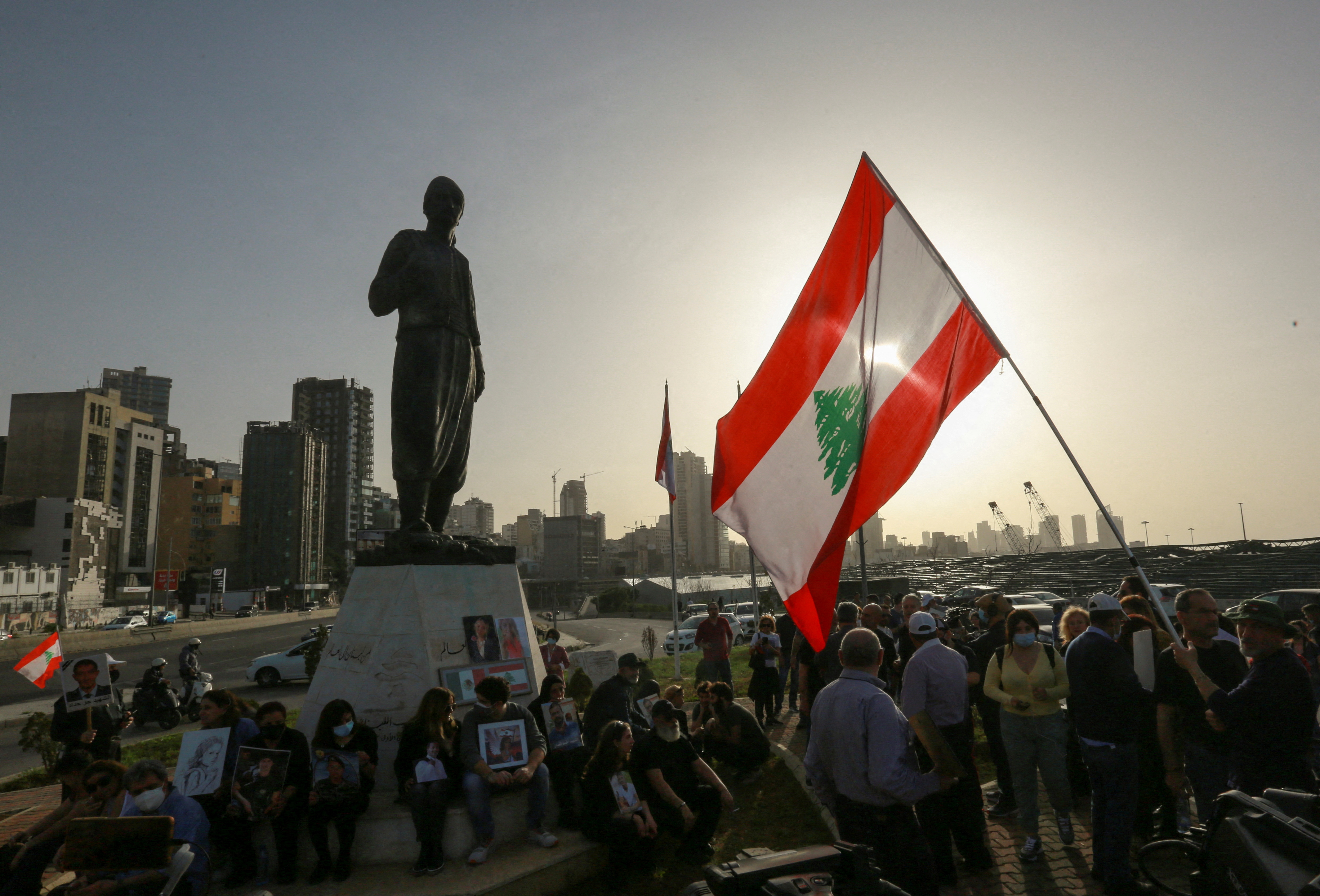 Families of the victims of the 2020 Beirut port explosion hold pictures during a protest near Beirut port, Lebanon April