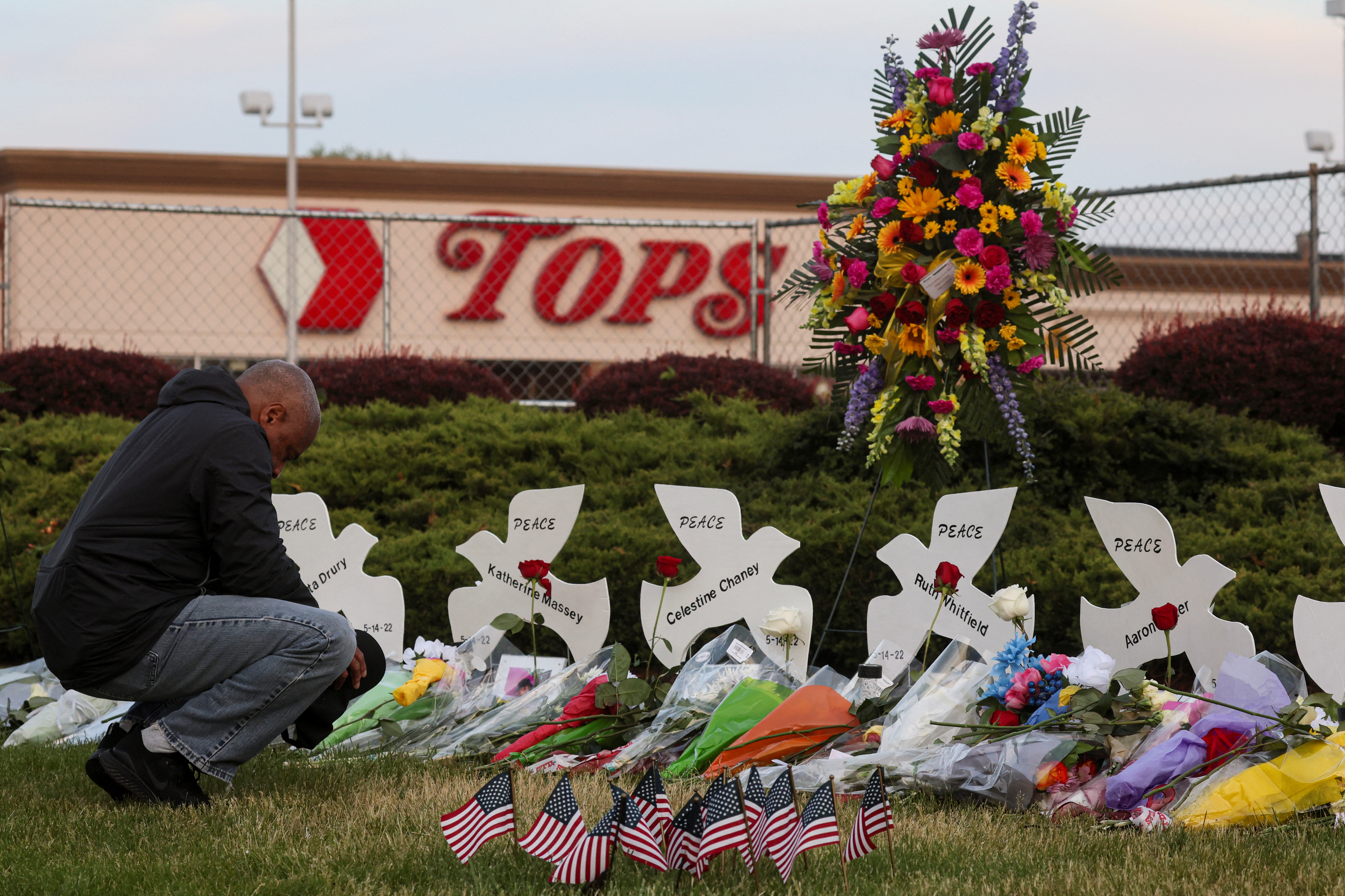 A man prays outside the site of a deadly shooting in Buffalo, New York