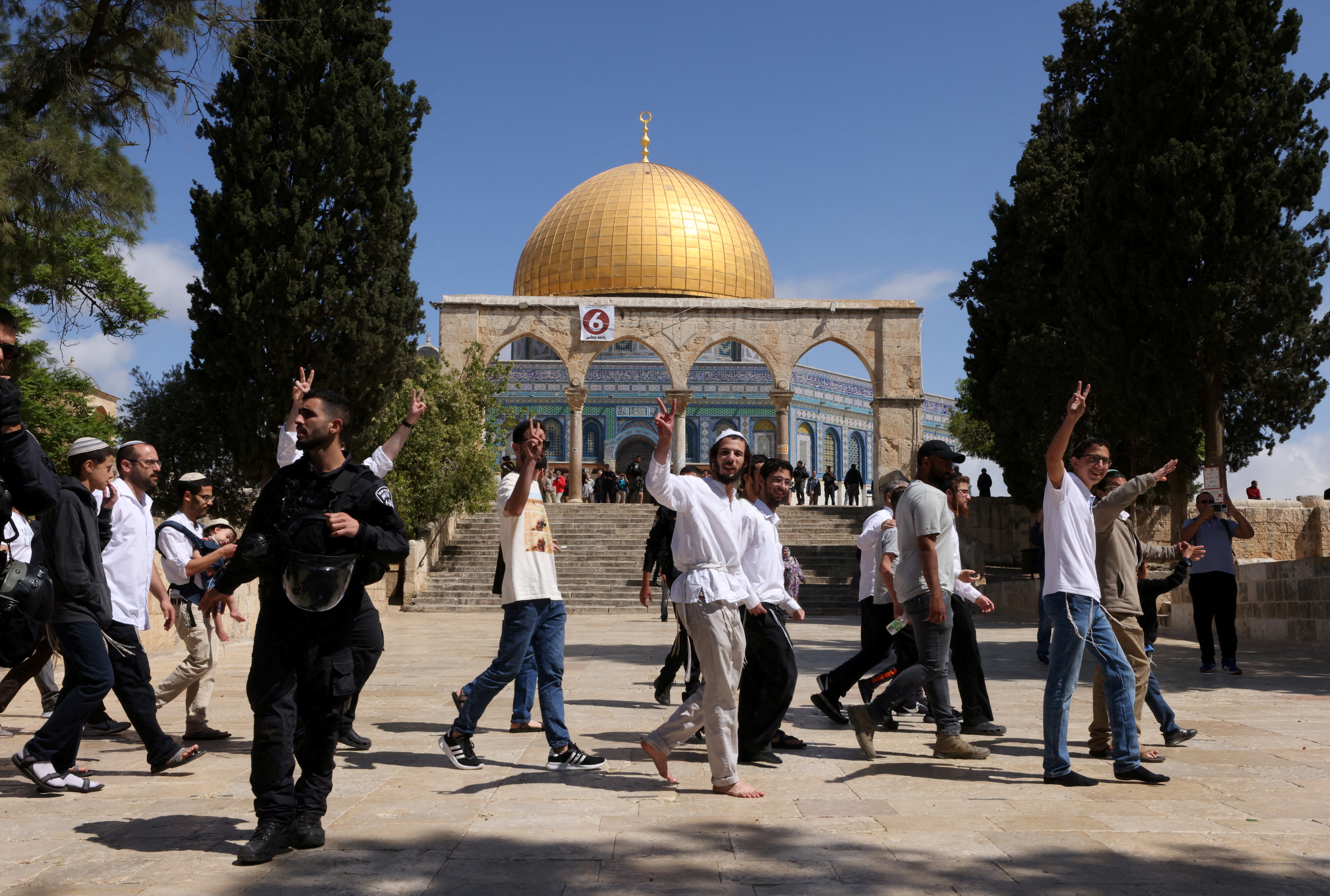 FILE PHOTO: Jewish visitors gesture as Israeli security forces secure the area at the compound that houses Al-Aqsa Mosque, known to Muslims as Noble Sanctuary and to Jews as Temple Mount, in Jerusalem's Old City