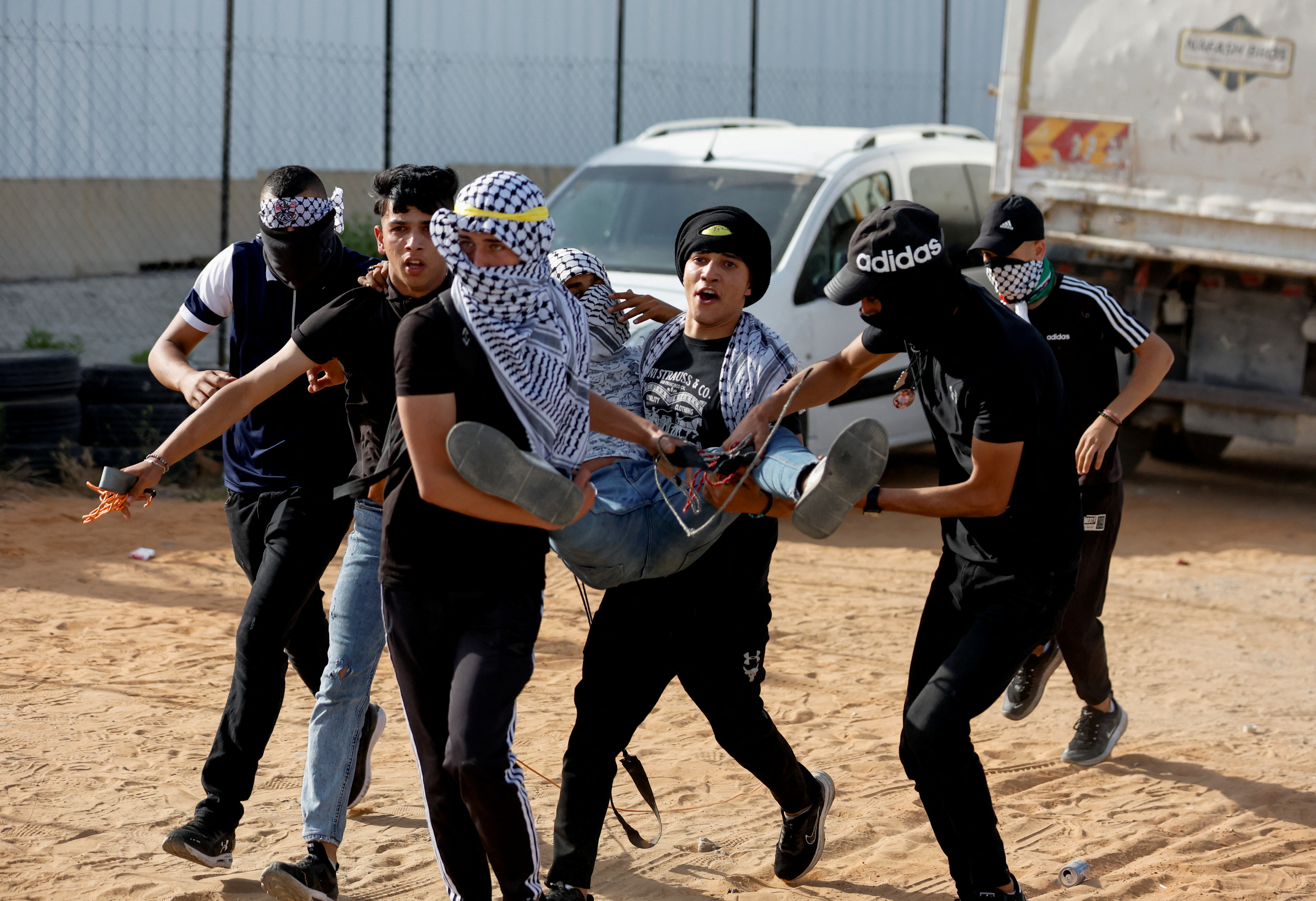 A wounded Palestinian is carried amid clashes with Israeli forces during a protest over tensions in Jerusalem's Al-Aqsa Mosque, known to Muslims as Noble Sanctuary and to Jews as Temple Mount, near the Israeli settlement of Beit El in the Israeli-occupied West Bank