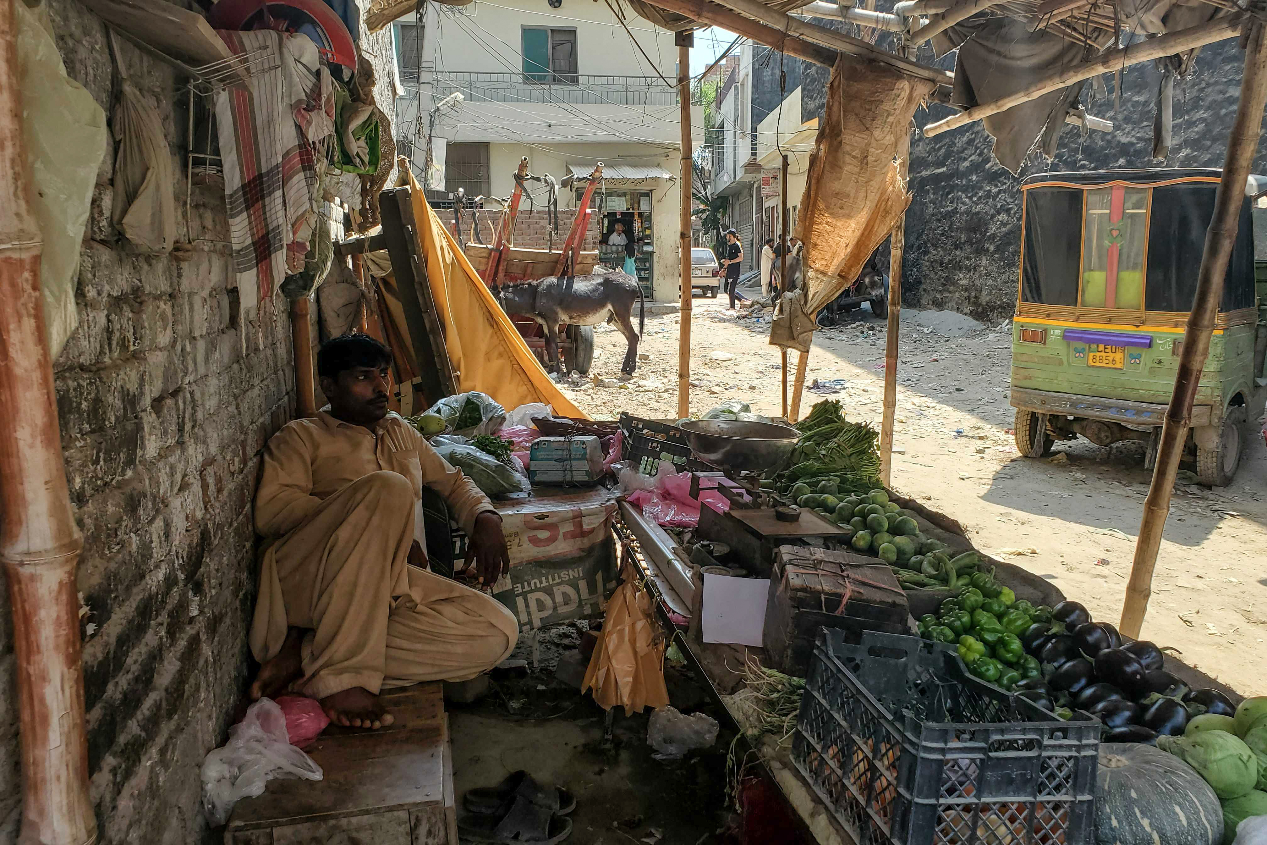 A vegetable vendor waits for customers