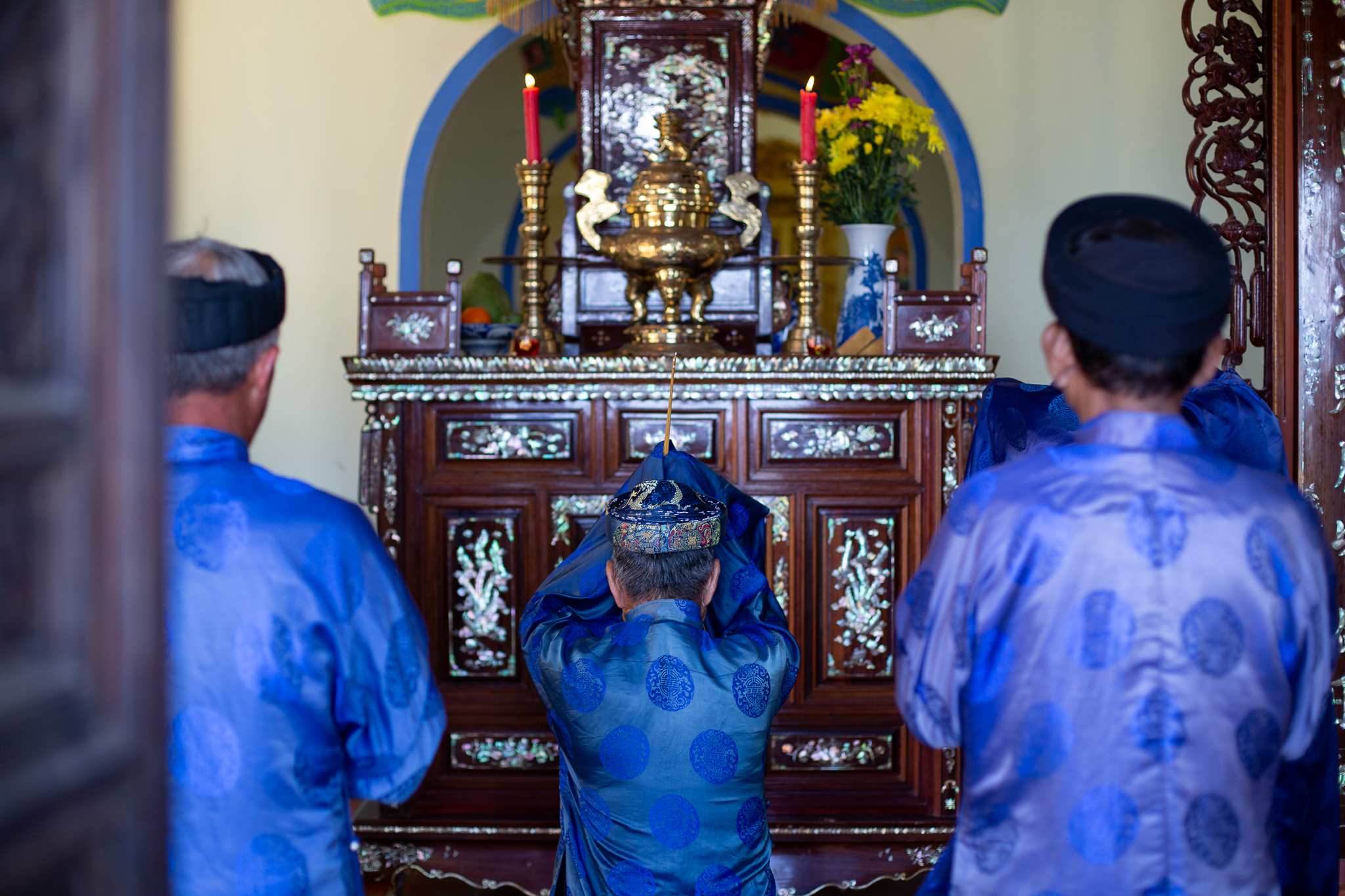 Worshippers bow and pray at a whale temple