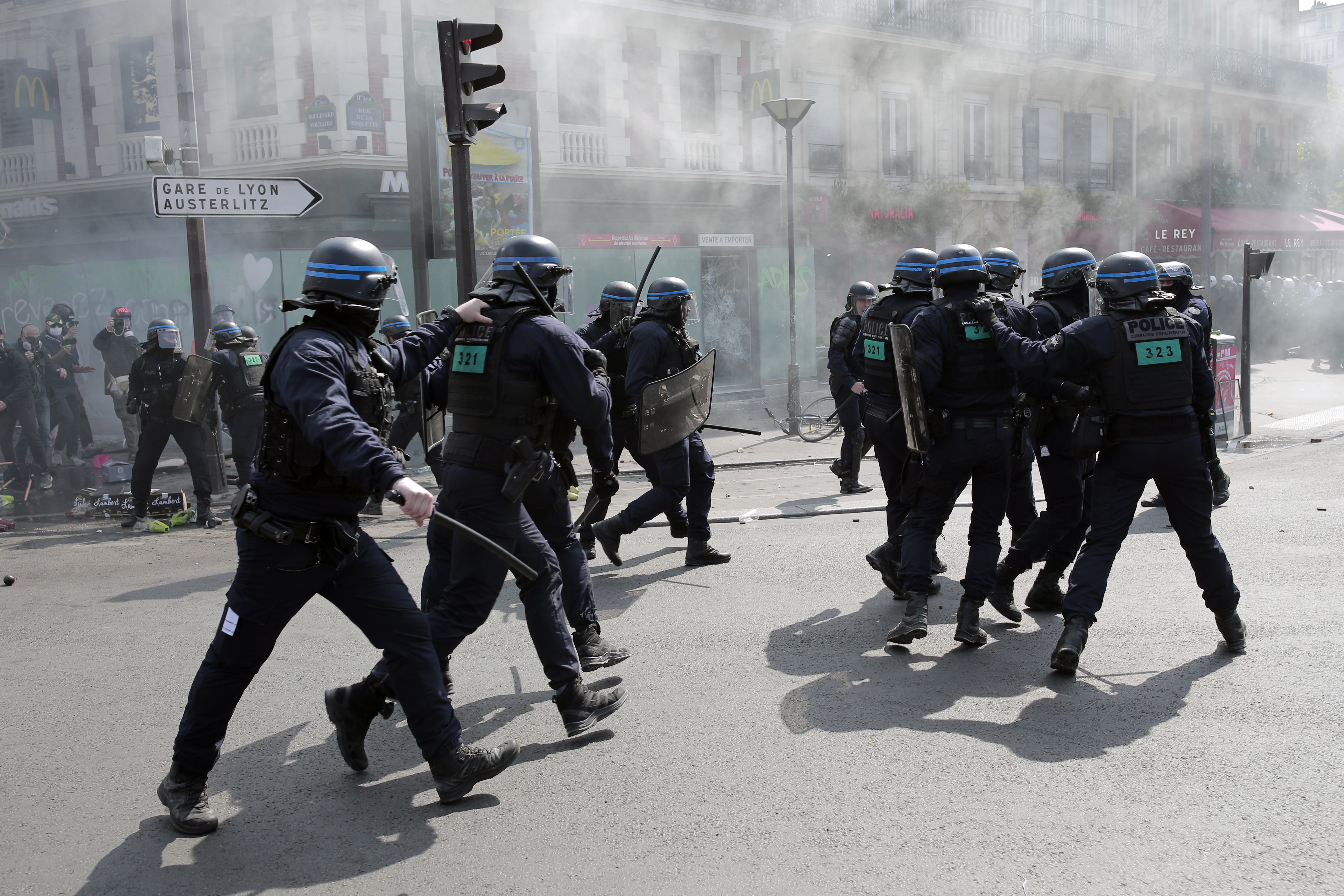 Riot police officers take positions during a May Day demonstration march from Republique, Bastille to Nation, in Paris, France, Sunday, May 1, 2022 [Lewis Joly/AP]