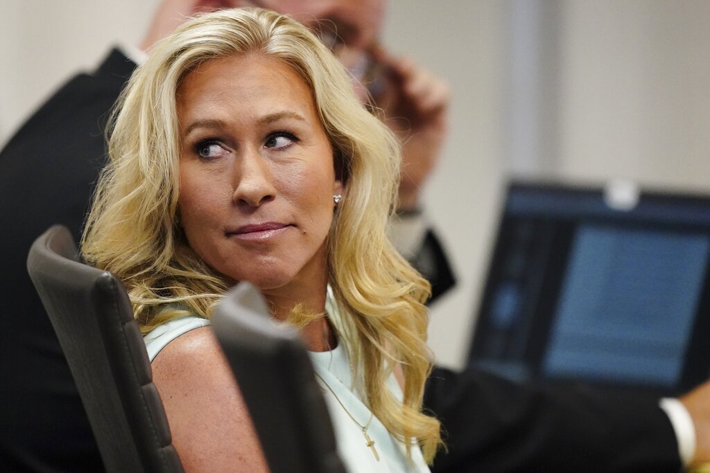 U.S. Rep. Marjorie Taylor Greene sits in a courtroom.