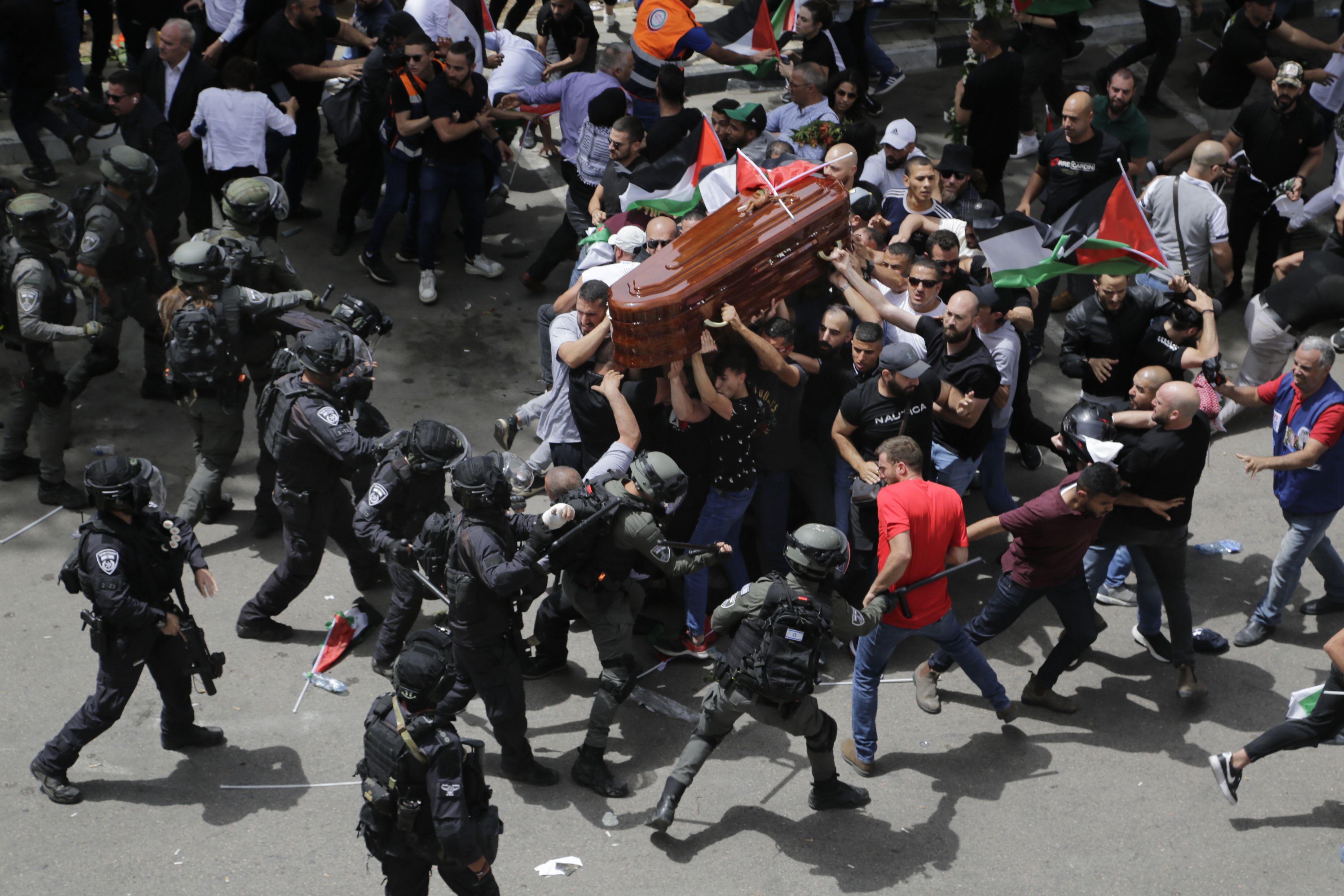 Israeli police confront with mourners as they carry the casket of slain Al Jazeera veteran journalist Shireen Abu