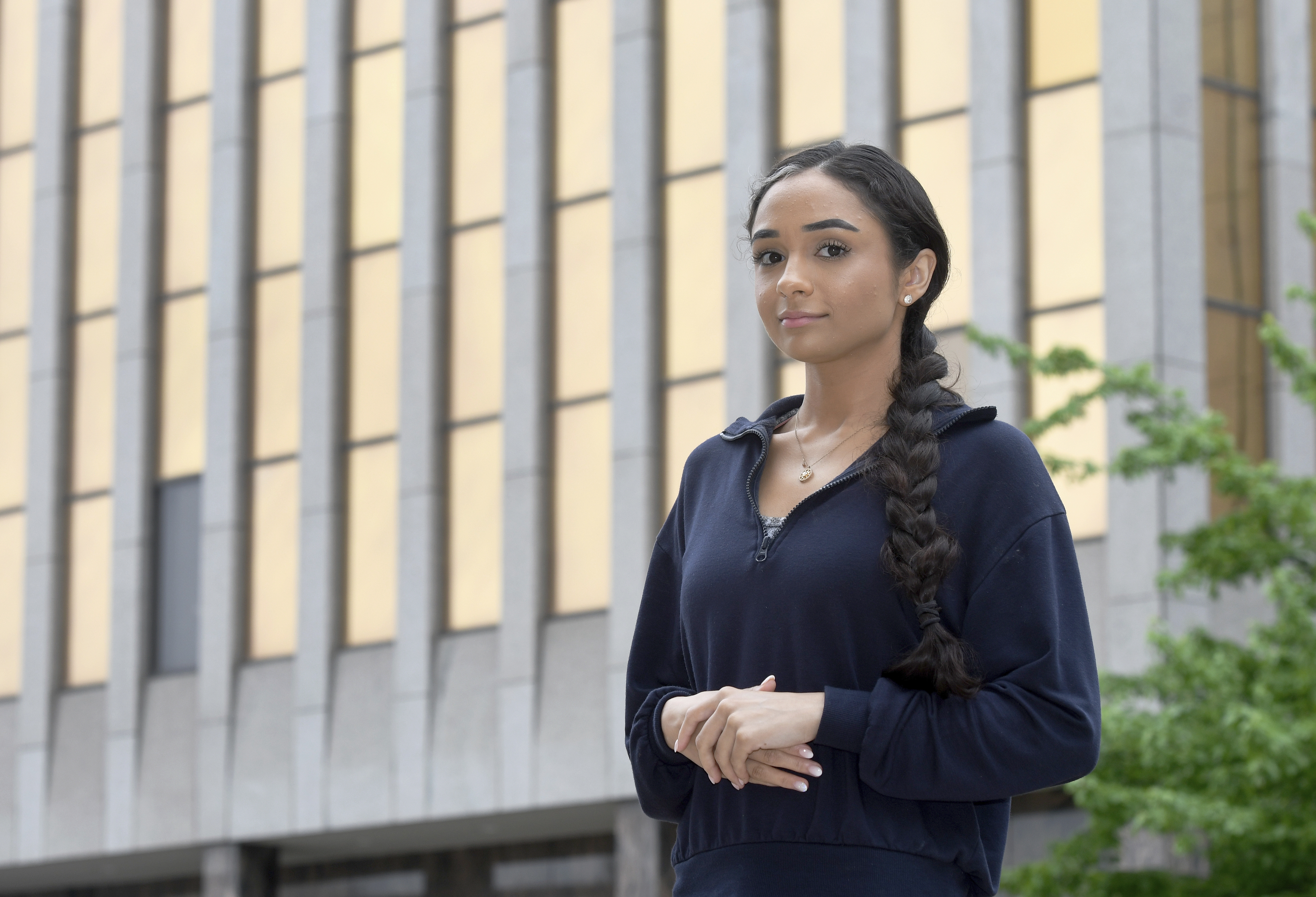 A young woman looks at the camera