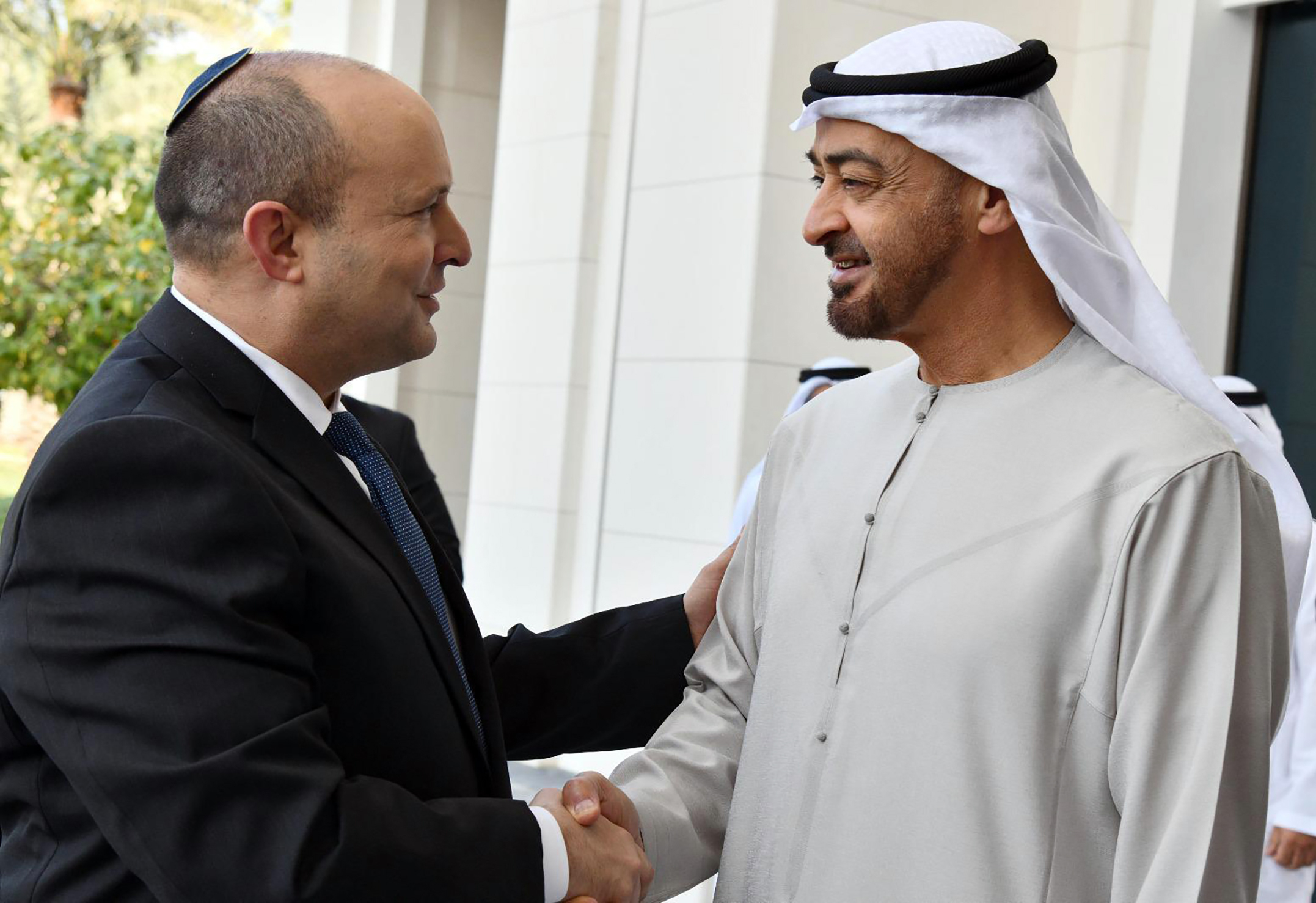 Israeli Prime Minister Naftali Bennett, left, shakes hands with Sheikh Mohammed bin Zayed Al Nahyan, then crown prince of Abu Dhabi in Abu Dhabi, United Arab Emirates, Dec. 13, 2021.