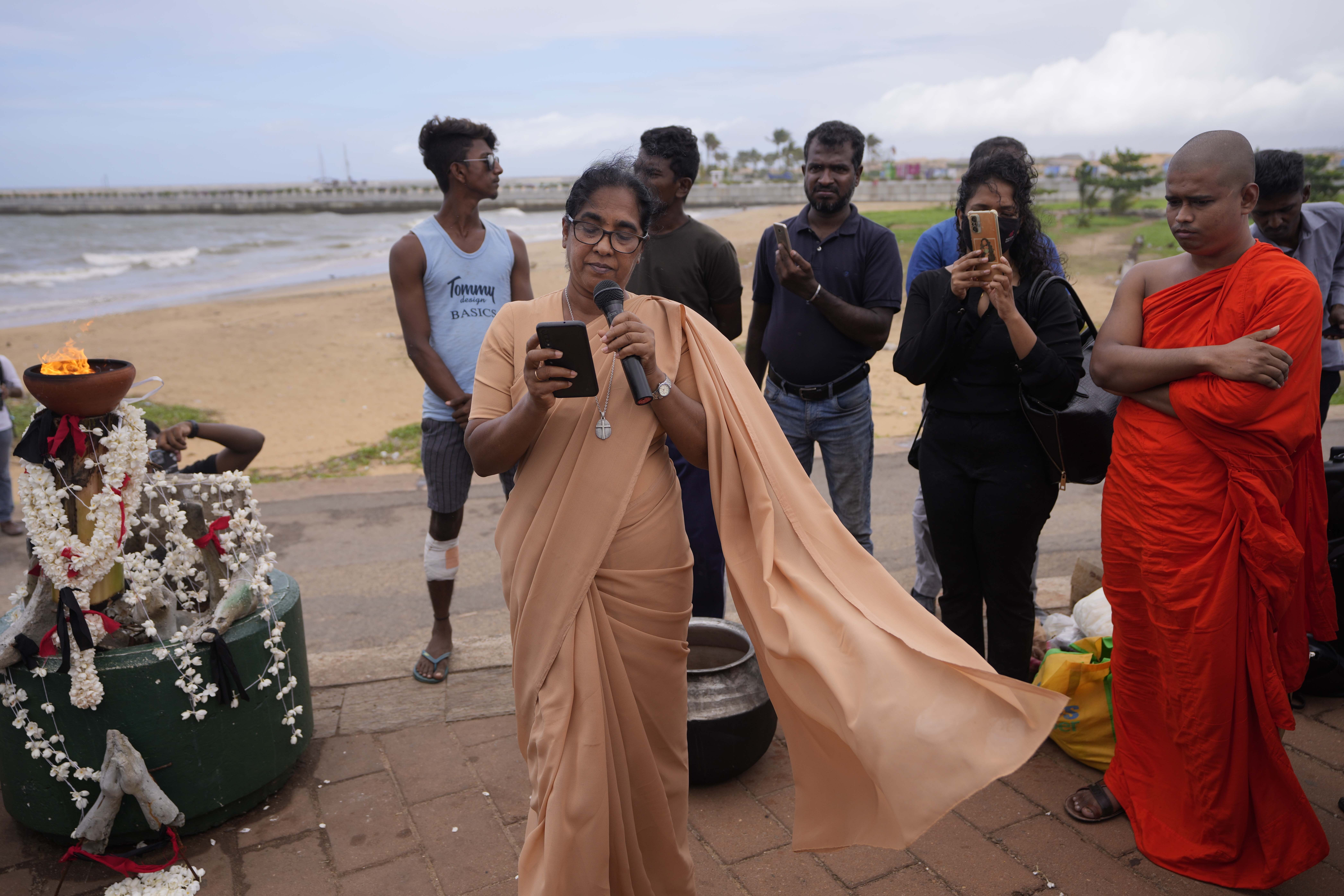 A Christian nun sings hymns as activists observe a minute silence in remembrance of victims of Sri Lanka's civil war.
