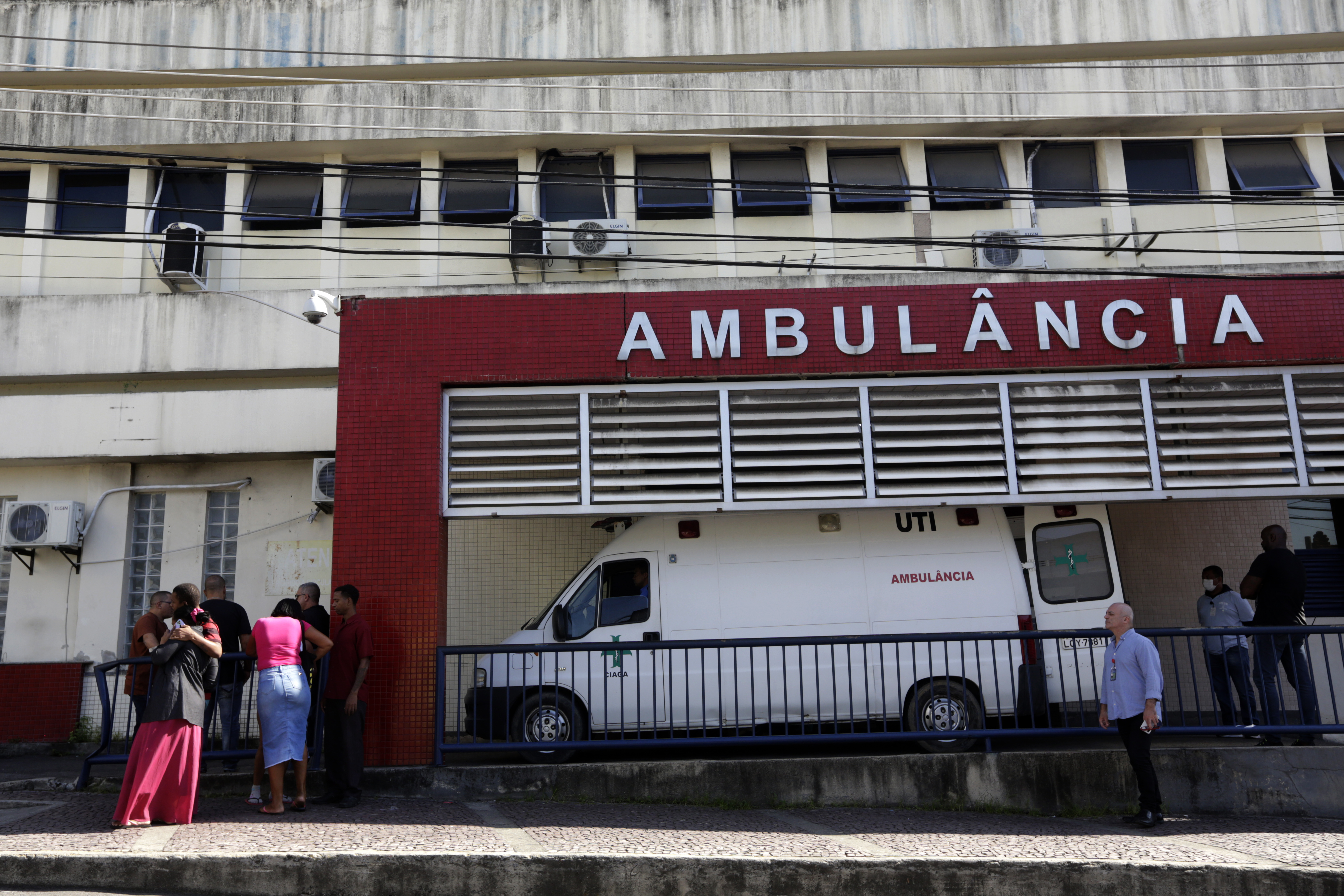 People wait outside a hospital in Rio de Janeiro, Brazil