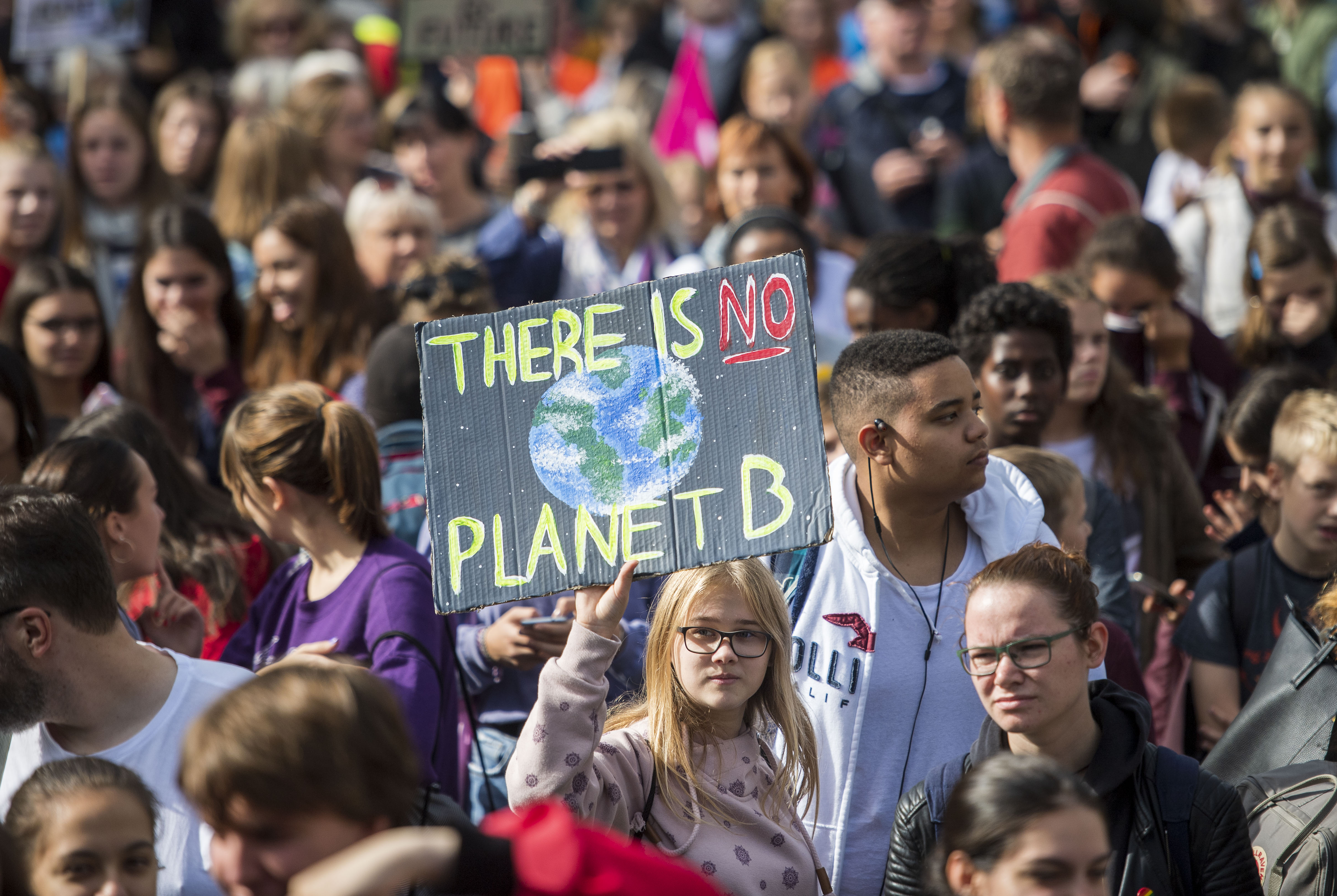 protester seen with a sign that reads 'there is no planet B'