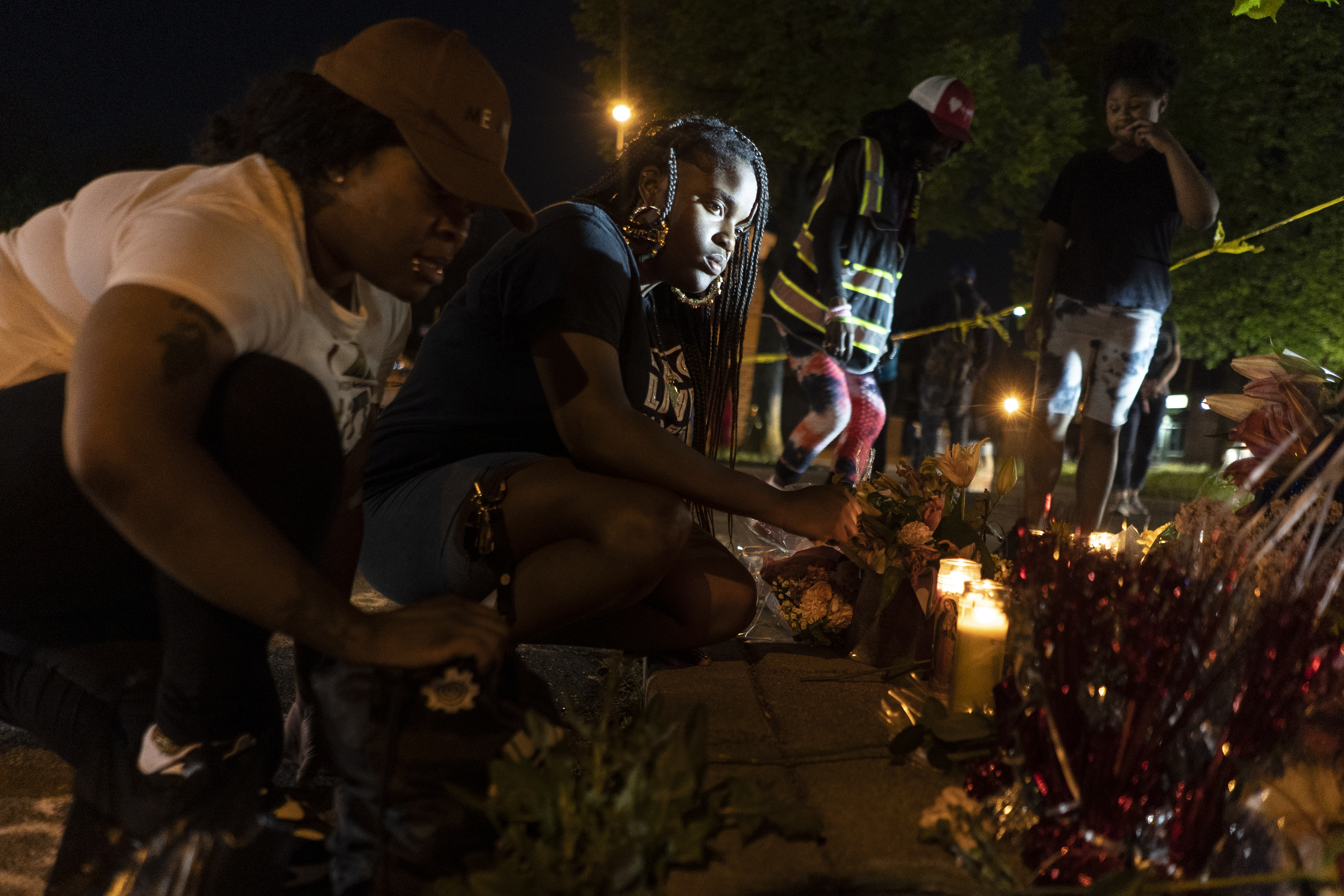 People honour victims of Buffalo massacre with candles at a memorial