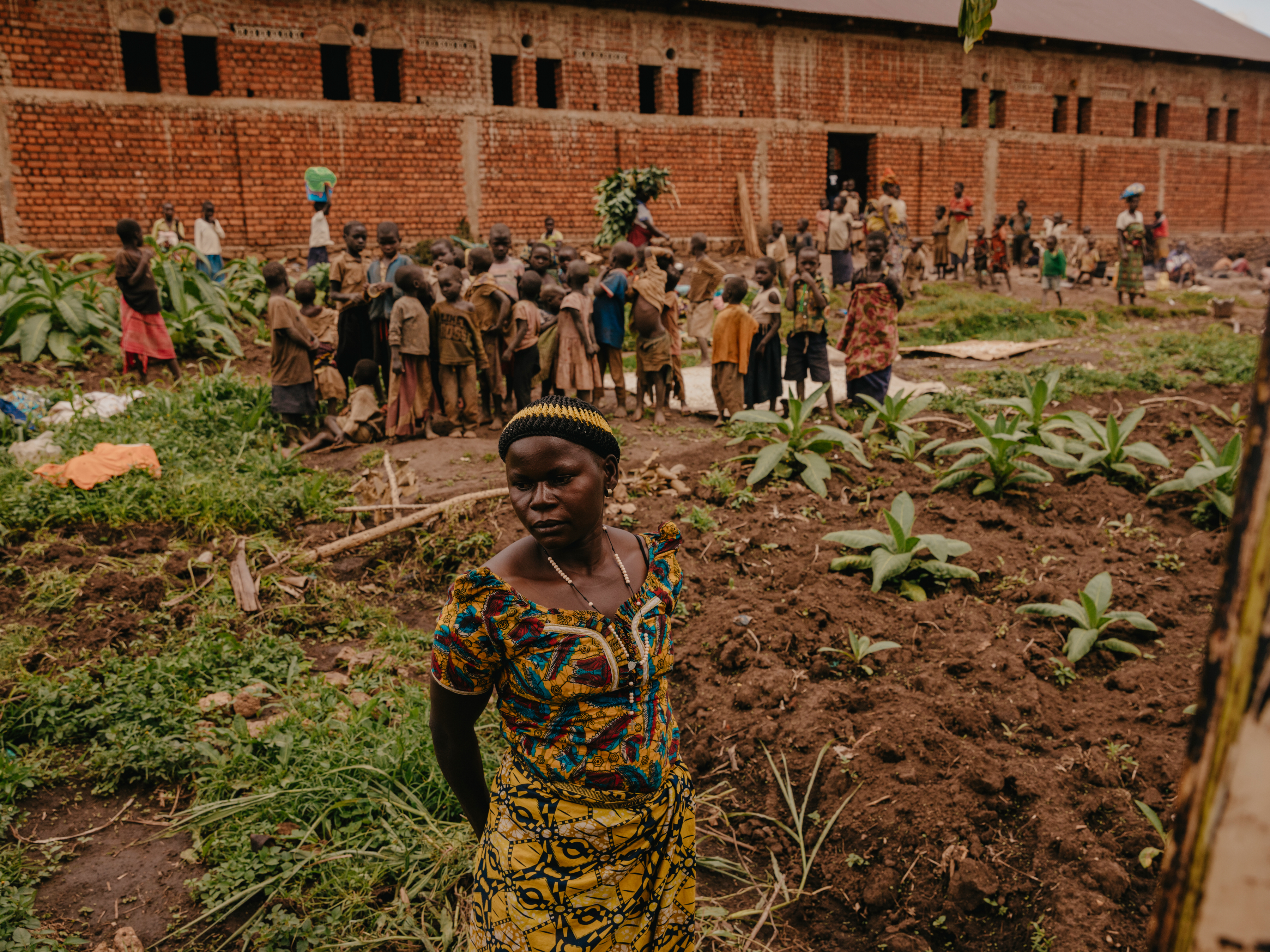 Dira* outside the church building she now lives in with her two children in Ngote, Ituri Province. ‘We fled when the war reached us and we heard gunshots. Now if you try to approach our old village you will be killed or chased away. But we have to return to look for vegetables to eat. You have to be quick, and go by night.”