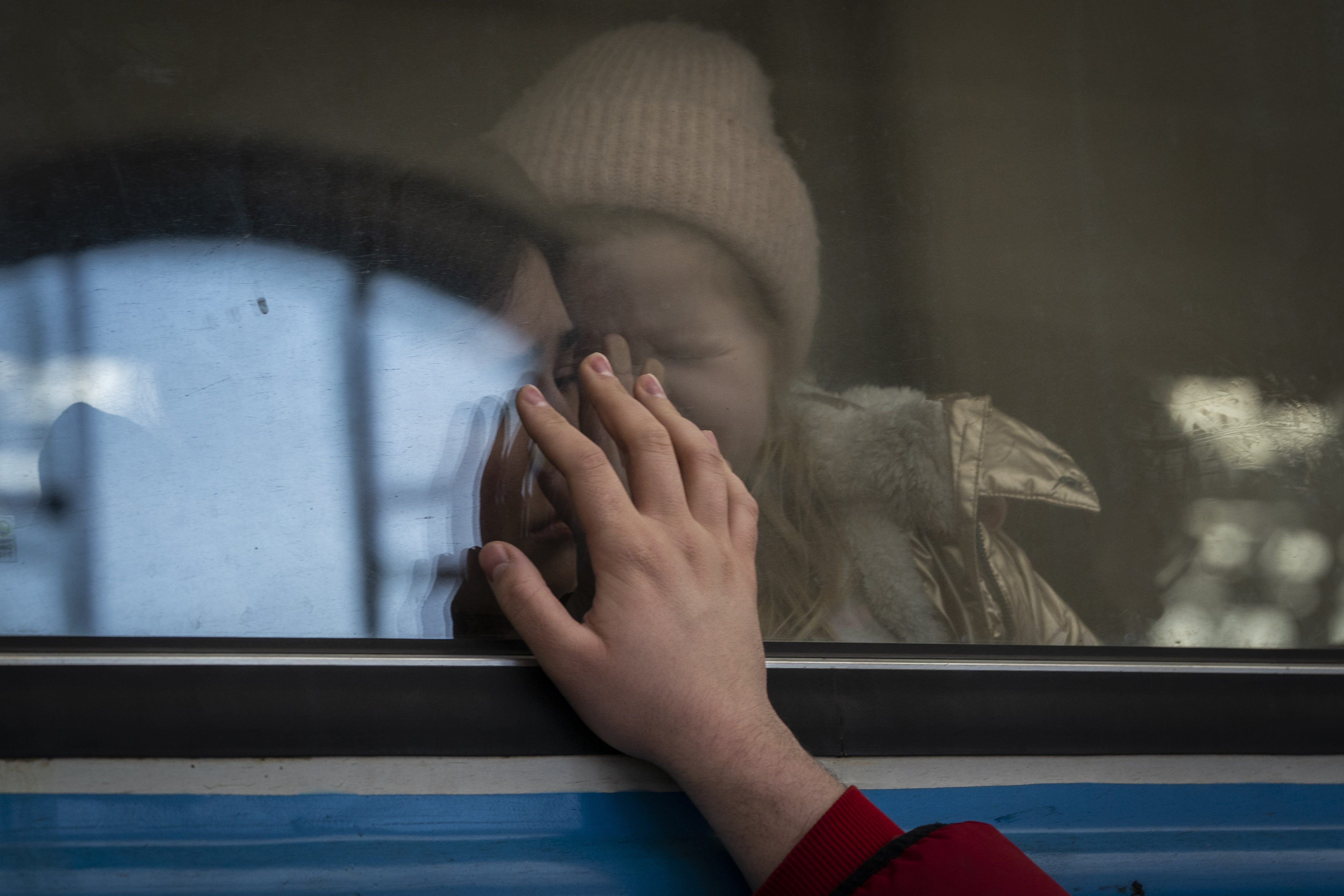 Displaced Ukrainians on a Poland-bound train bid farewell in Lviv, western Ukraine, Tuesday, March 22, 2022