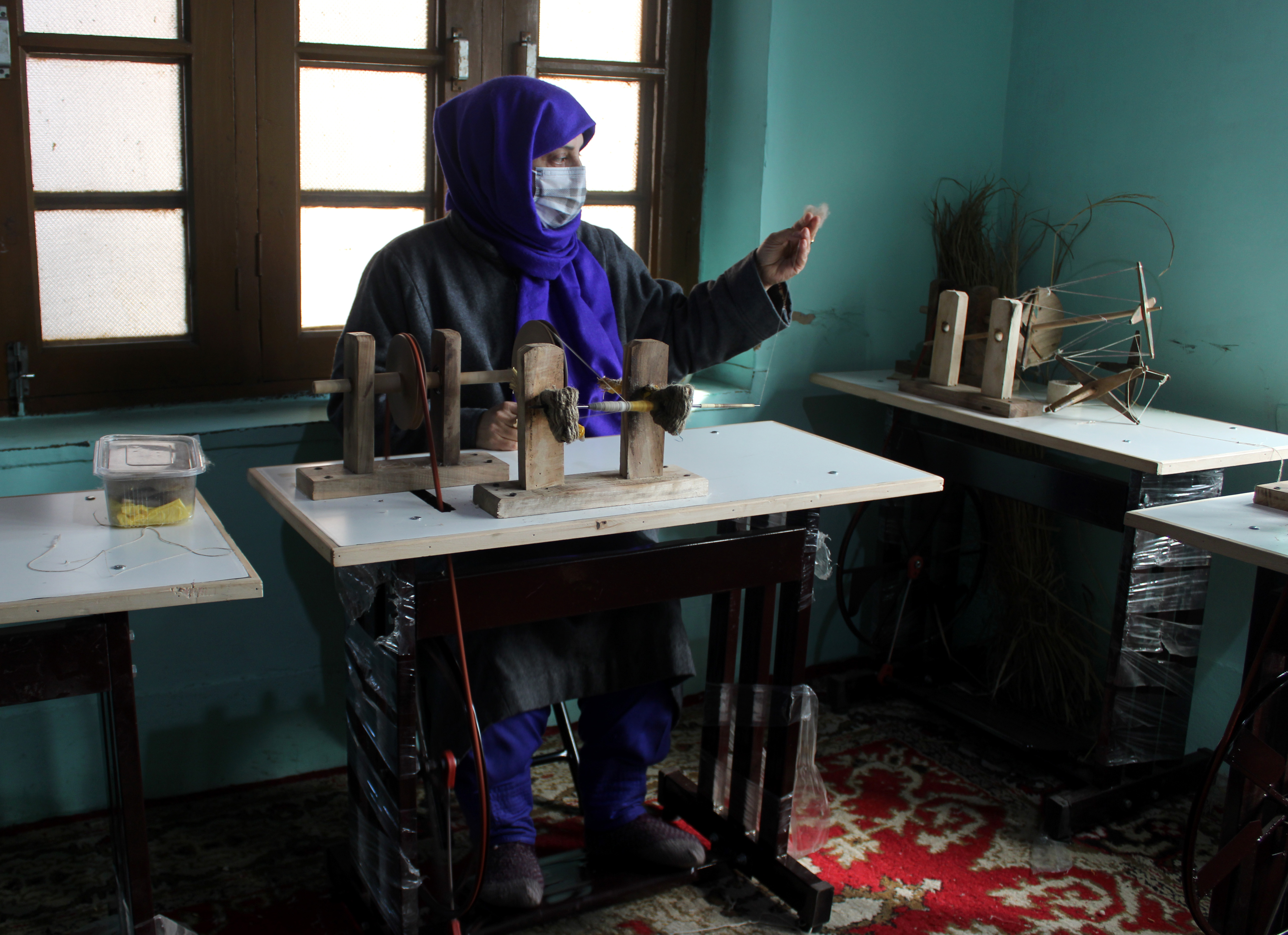 Shaista Bilal working on a spinning wheel which works with a pedal