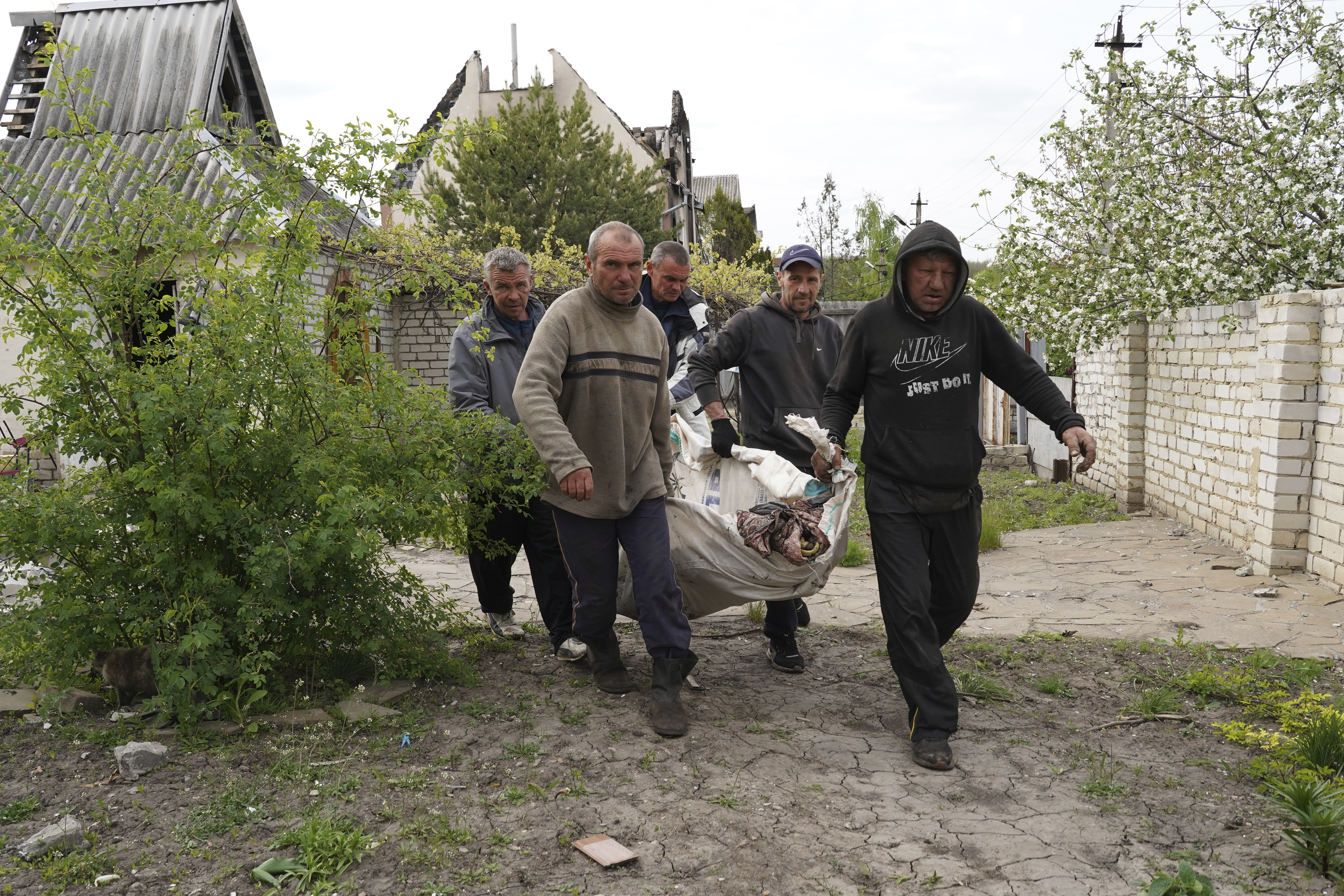 Volunteers exhume the bodies of civilians killed by Russian shelling in the village of Stepaky, close to Kharkiv.