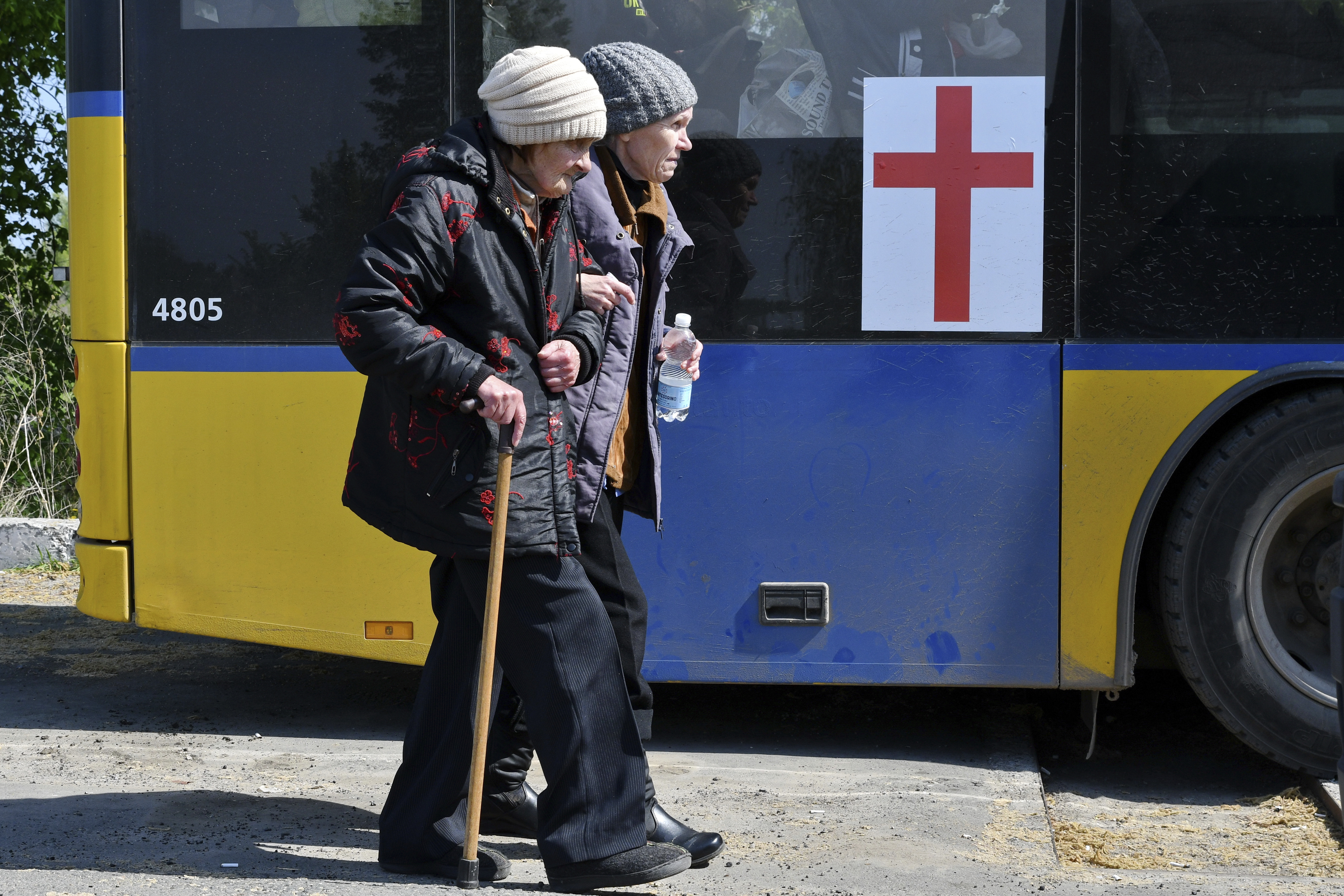 Women board a bus during an evacuation of civilians on a road near Slovyansk, eastern Ukraine