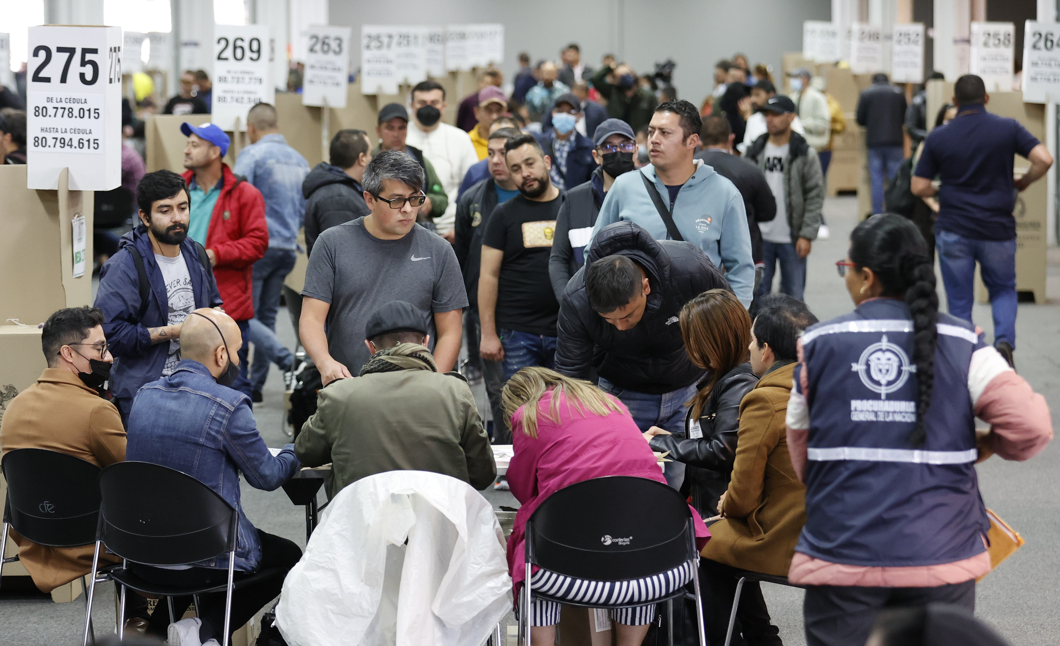 People attend to voting during the first round of presidential elections at Corferias voting centre in Bogota,
