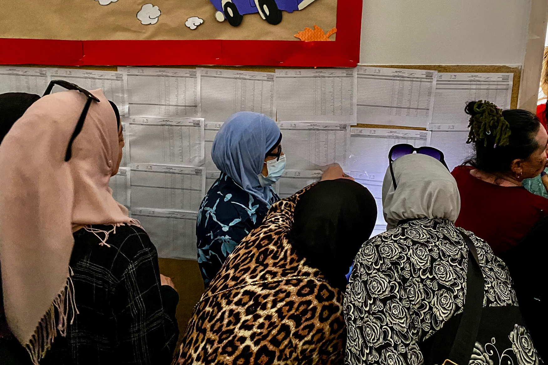 Voters and staff at a polling station in a Beirut school rely on phone flashlights and battery-powered lamps due to power cuts
