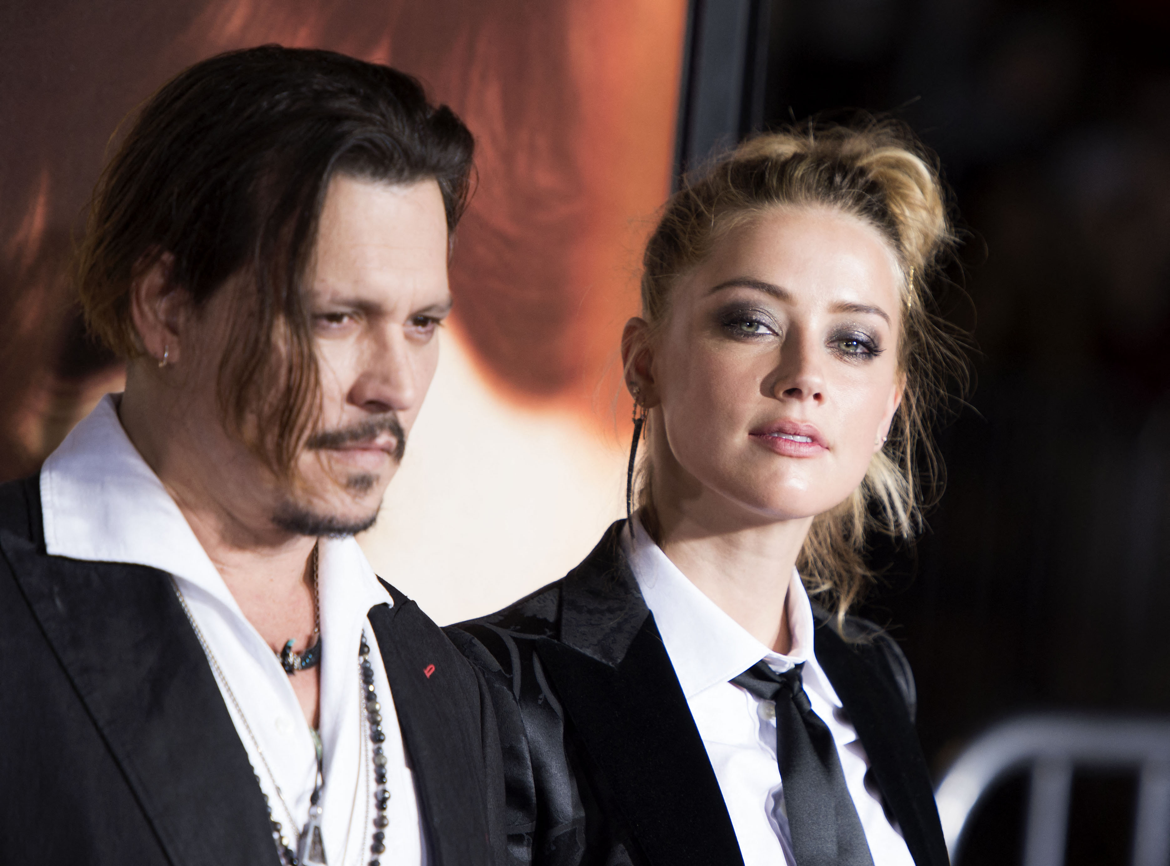 (FILES) In this file photo taken on November 21, 2015 Actors Johnny Depp (L) and Amber Heard attend the Los Angeles Premiere of "The Danish Girl", in Westwood, California. - A US jury on June 1, 2022found Johnny Depp and Amber Heard defamed each other, but sided far more strongly with the "Pirates of the Caribbean" star following an intense libel trial involving bitterly contested allegations of sexual violence and domestic abuse. (Photo by VALERIE MACON / AFP)