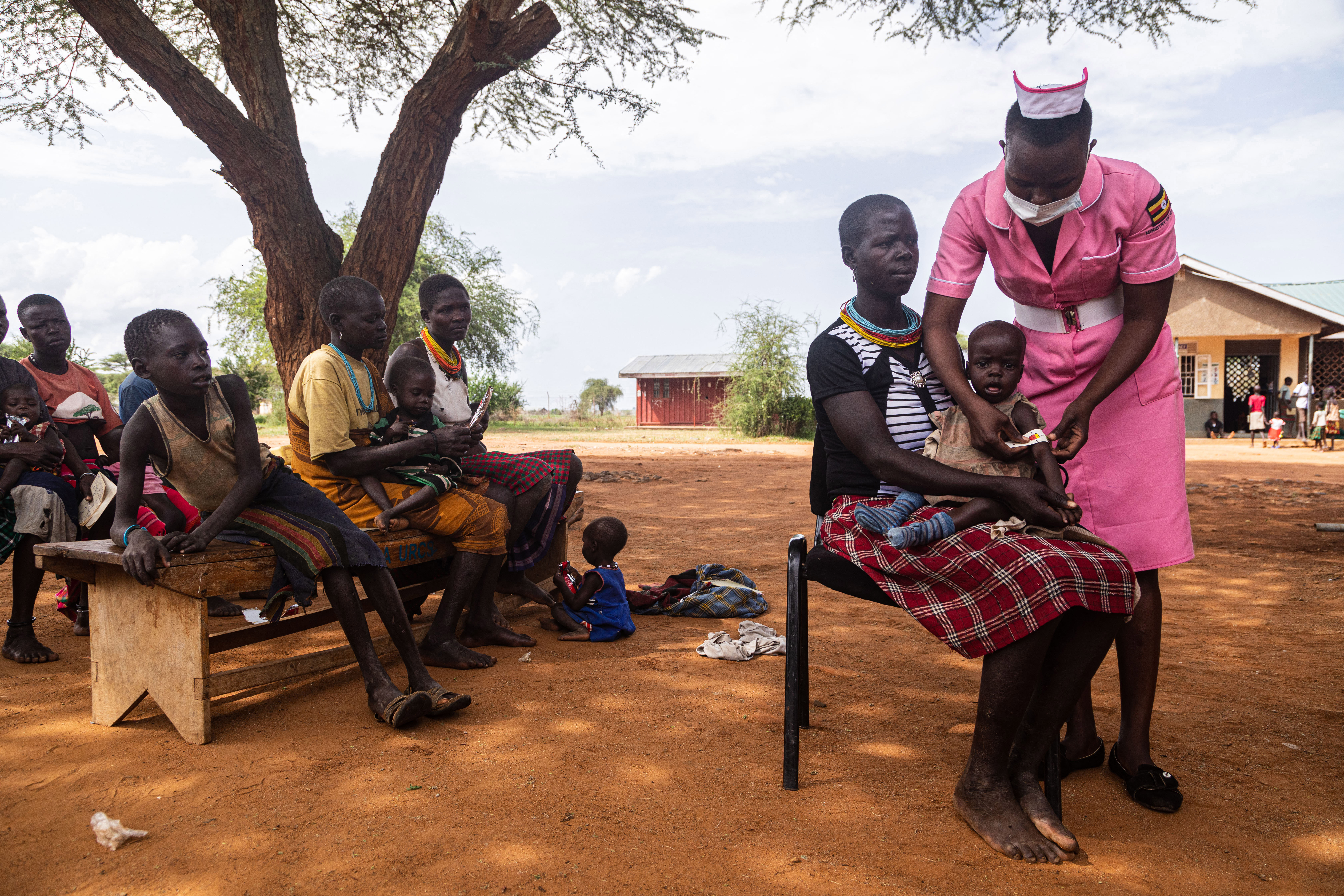 A nurse examines a malnourished child during a nutrition screening at Nadunget Health Centre