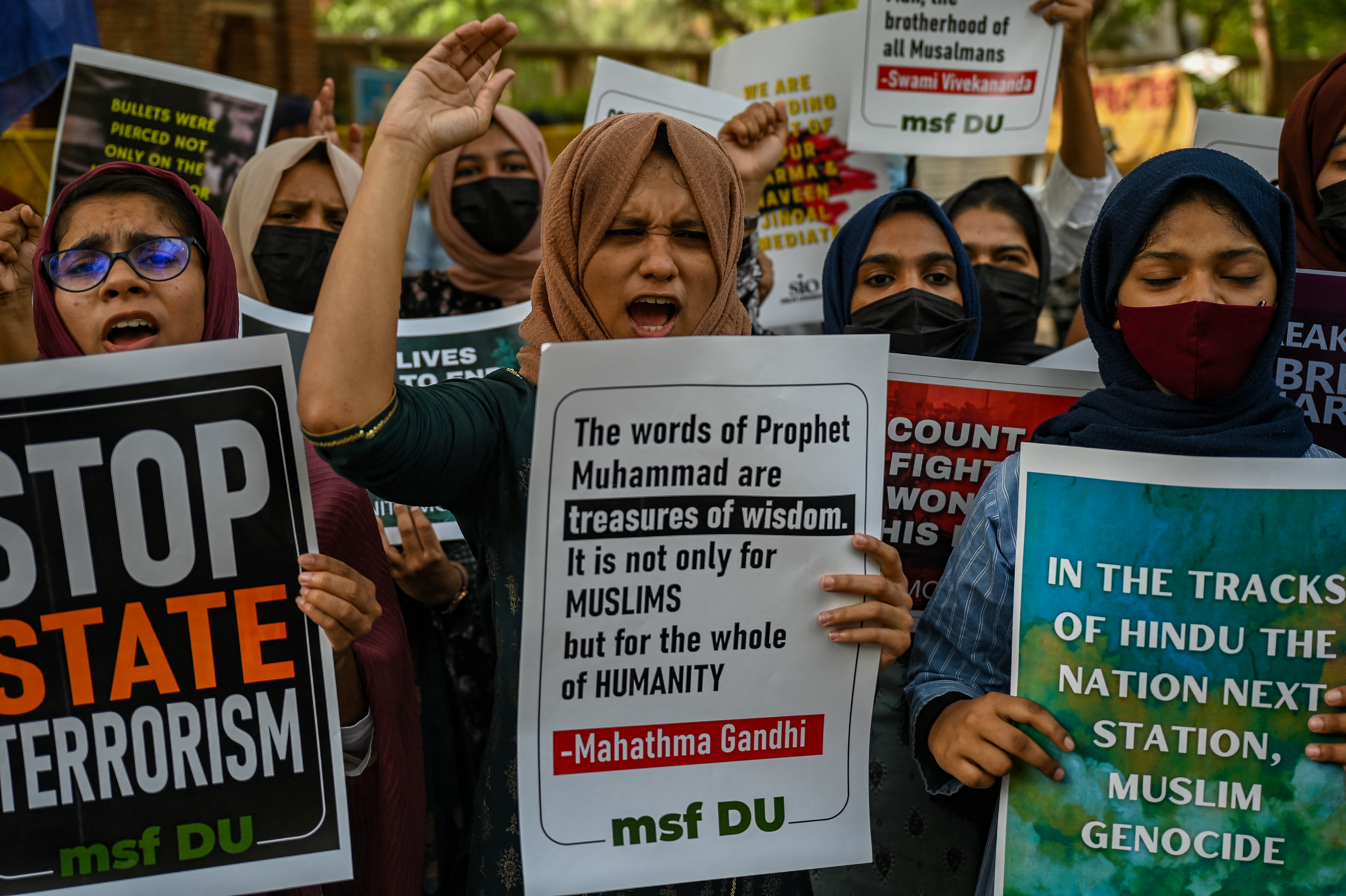 Students from Delhi university display placards and shout slogans during a demonstration to condemn police firing on a crowd protesting the remarks by a former spokesperson from the ruling party on Prophet Mohammed in the eastern Indian city of Ranchi, in New Delhi
