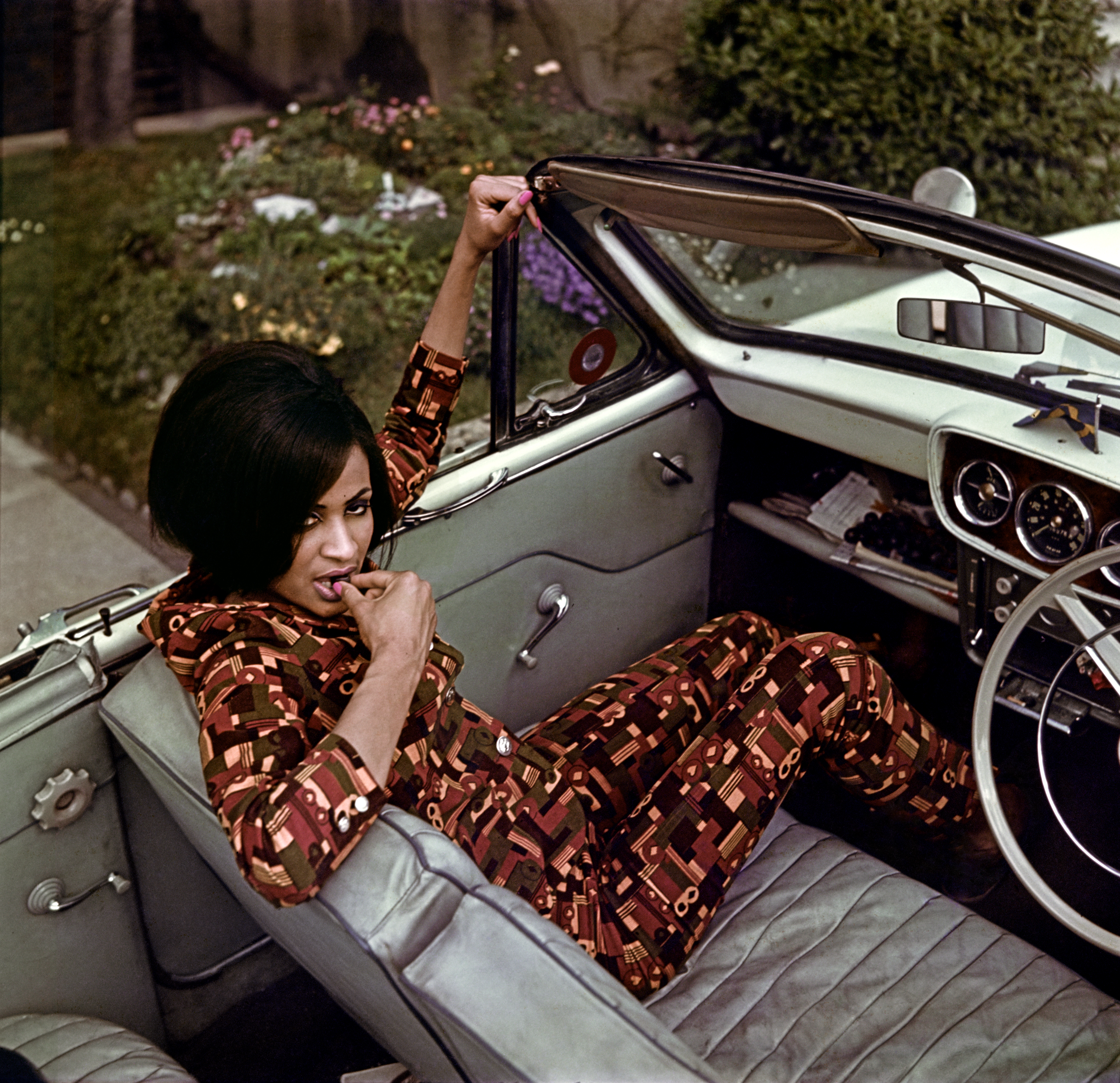 A woman sits in the front seat of a car