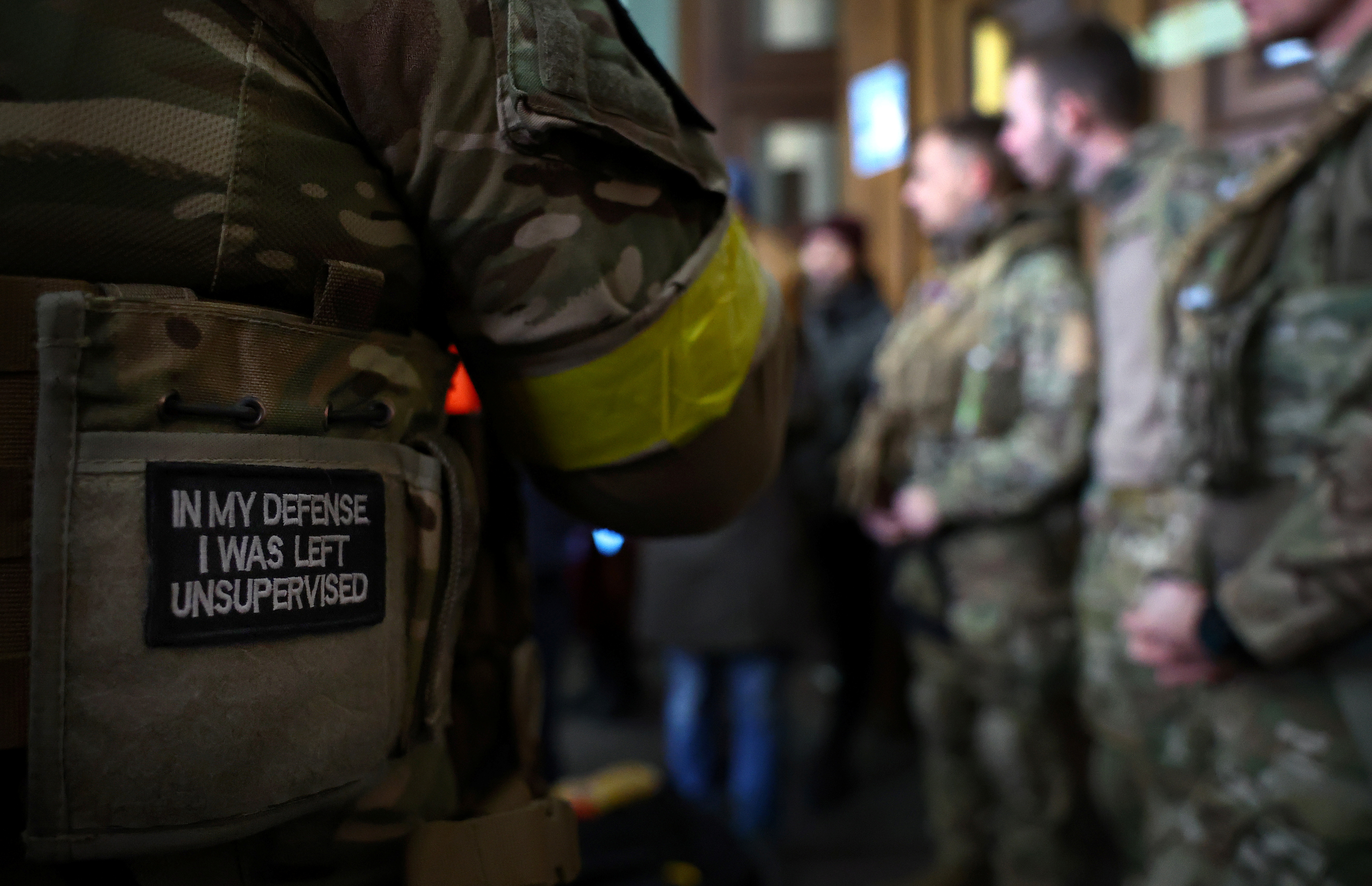 A badge on a uniform of a foreign fighter from the UK as he and other volunteers prepare to depart towards the front line in the east of Ukraine in March 2022 [Kai Pfaffenbach/Reuters]