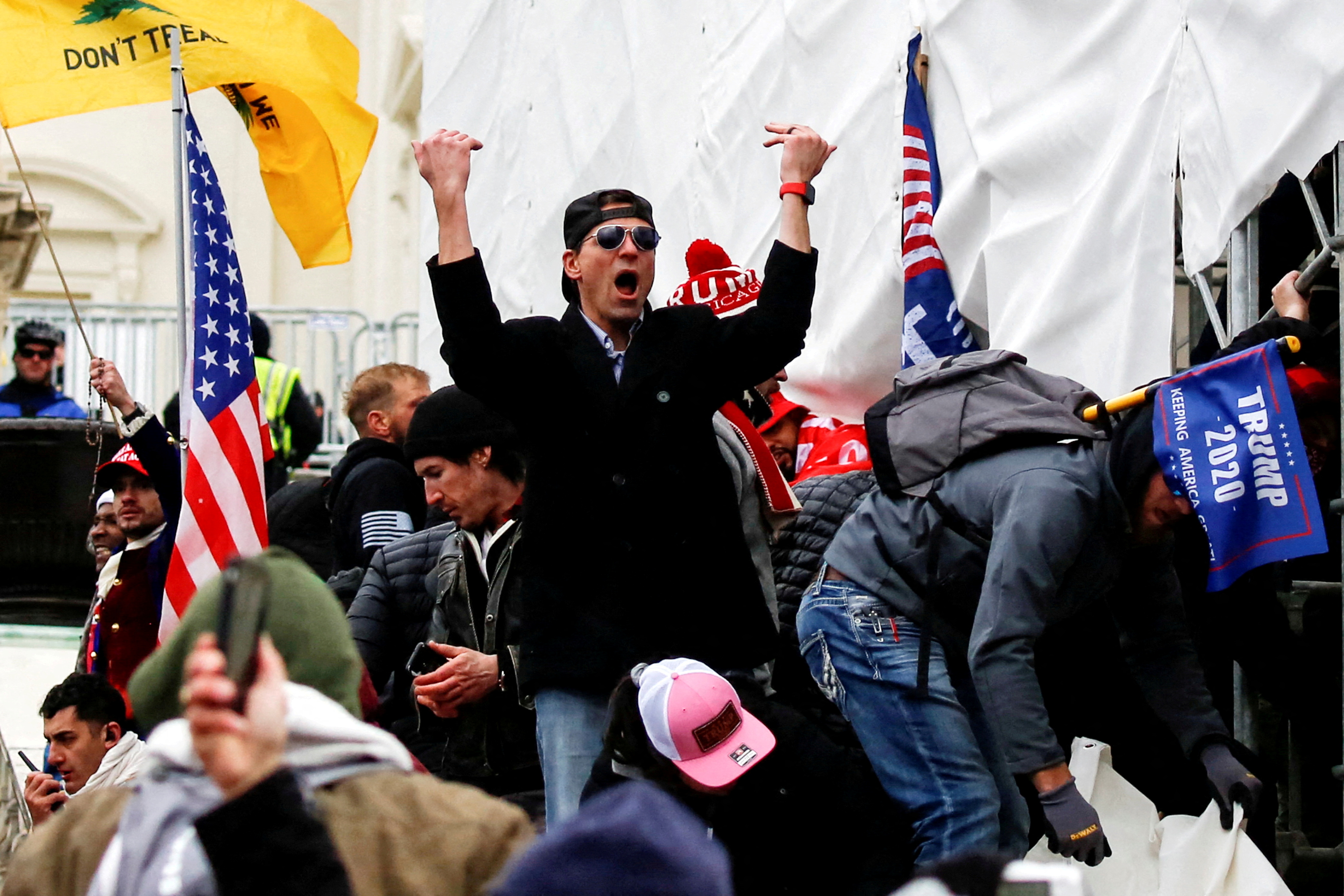 A man, identified as Ryan Kelley in a sworn statement by an FBI agent, gestures as supporters of U.S. President Donald Trump make their way past barriers at the US Capitol