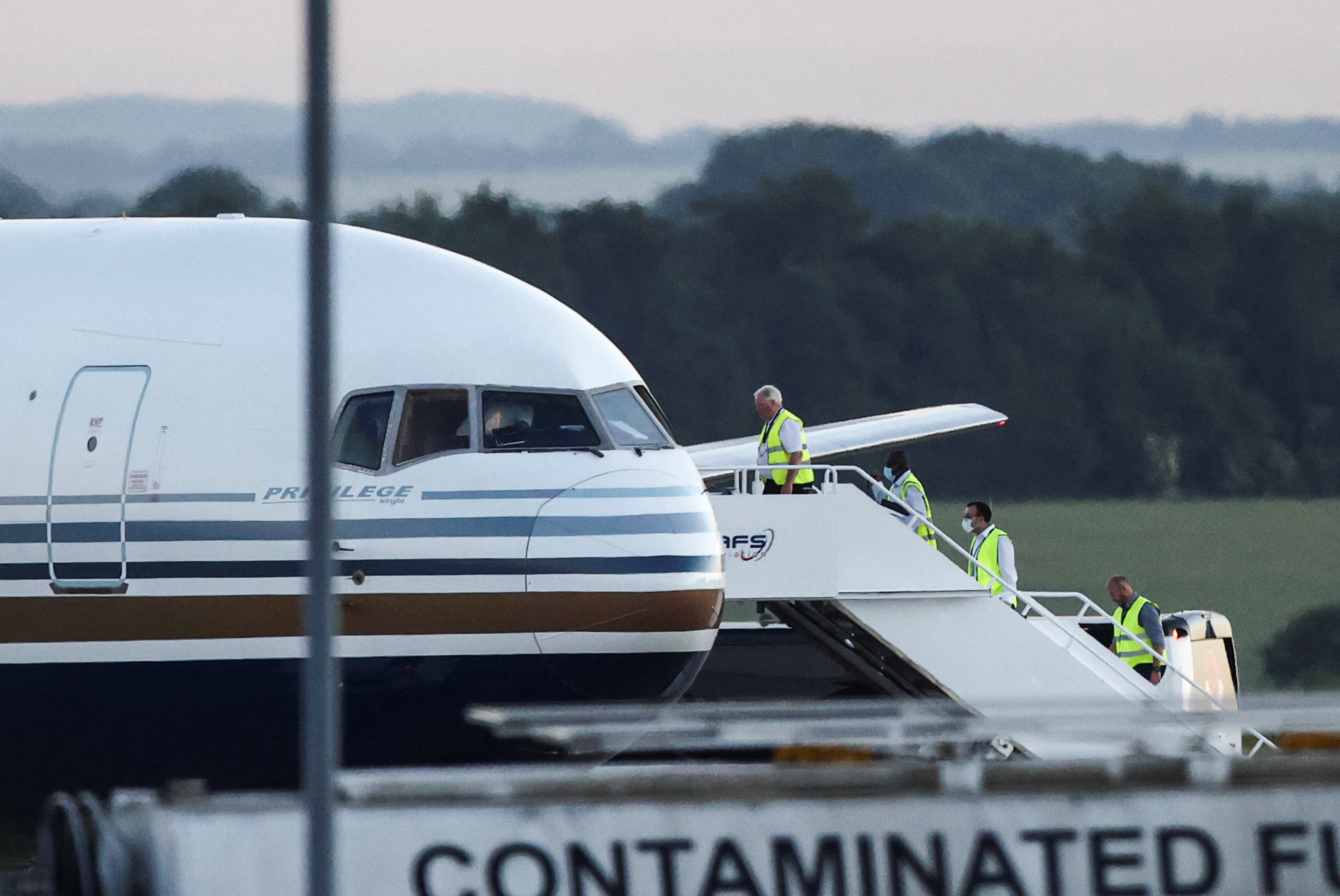 Members of staff board a plane at Boscombe Down air base in Wiltshire, UK.