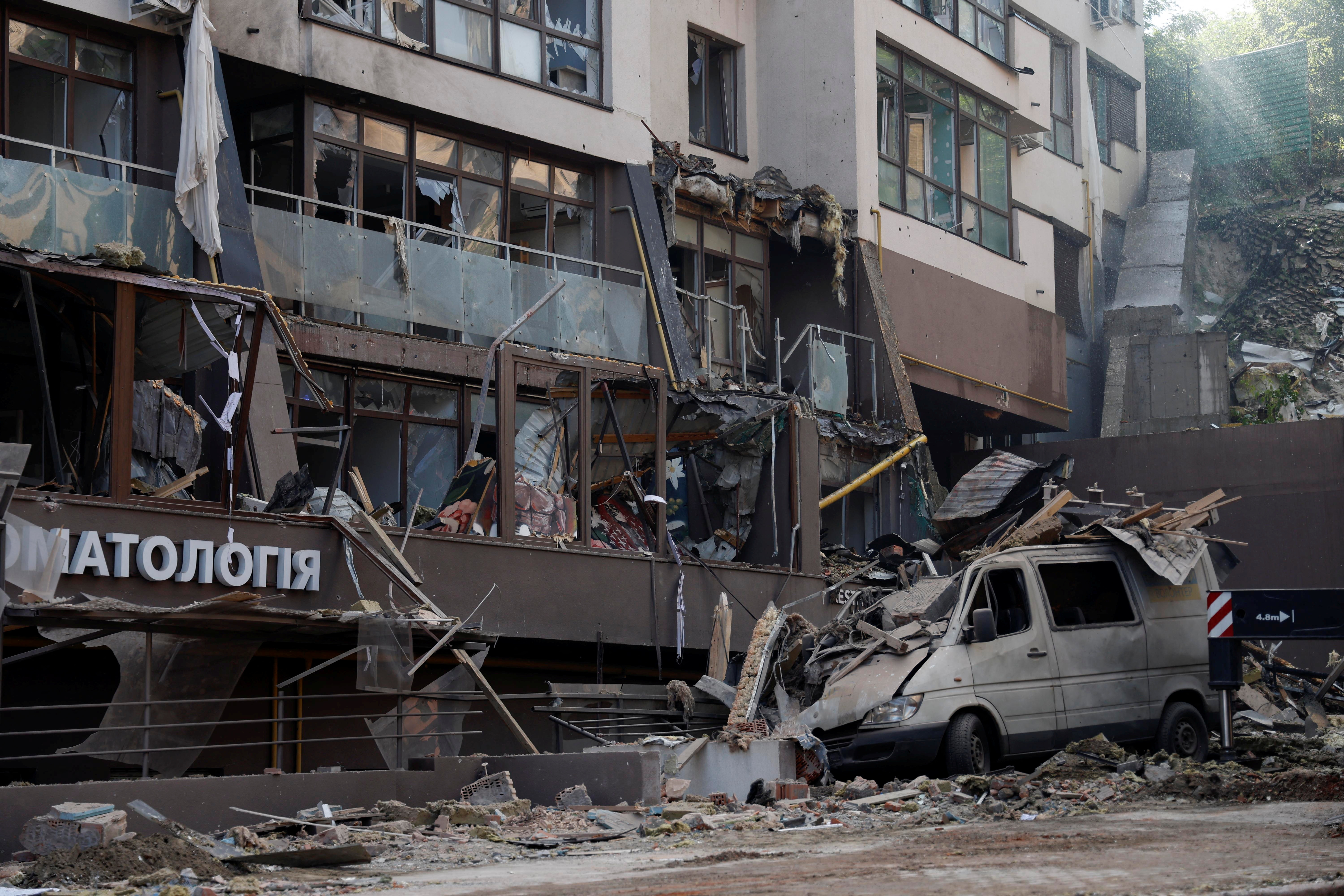 A damaged vehicle is seen outside a residential building hit by a Russian missile strike, as Russia's attack on Ukraine continues, in Kyiv, Ukraine June 26, 2022.