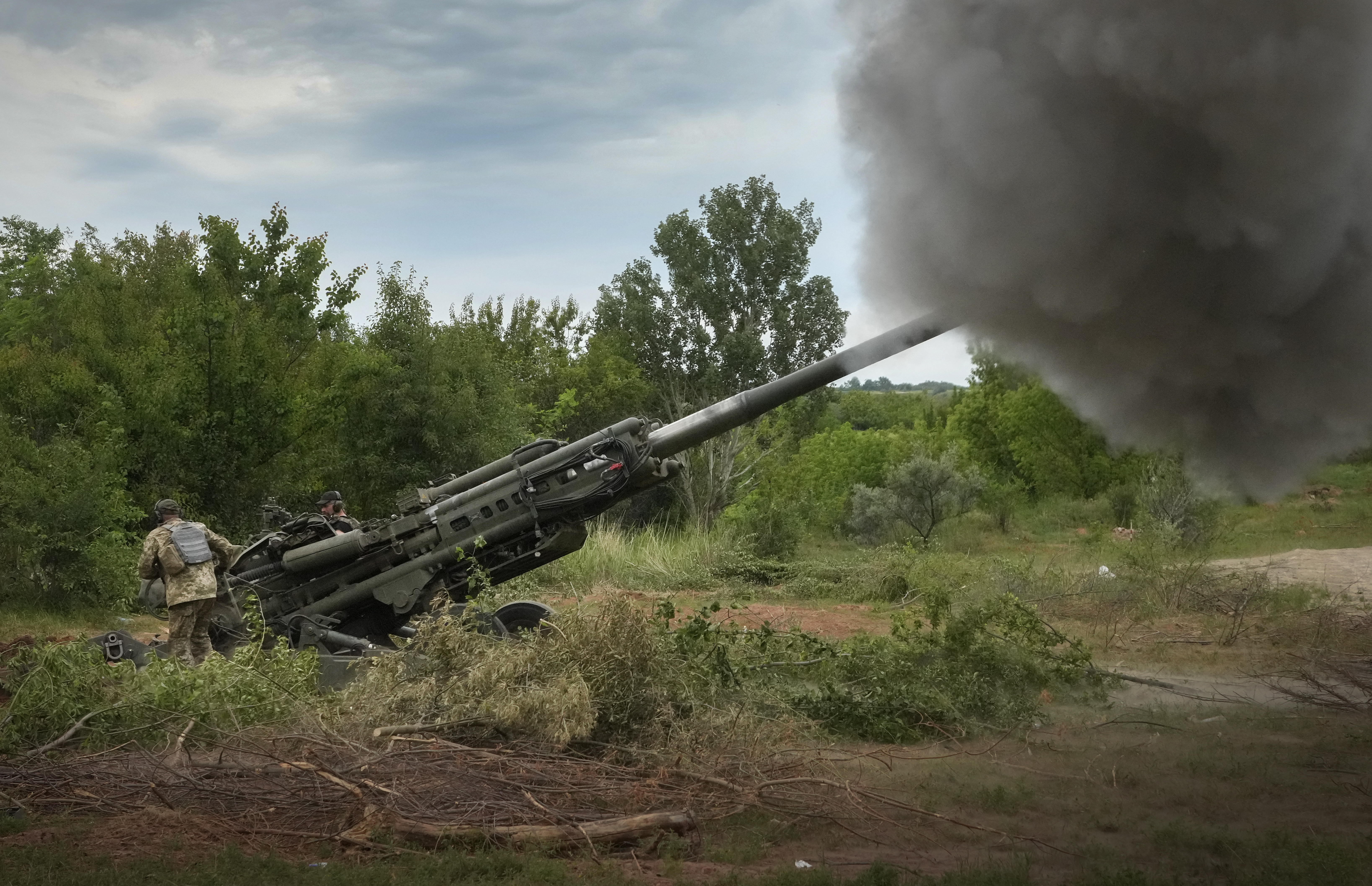 Ukrainian soldiers fire at Russian positions with a M777 howitzer.