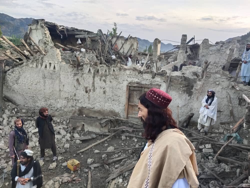 Afghans look at destruction caused by an earthquake in the province of Paktika, eastern Afghanistan