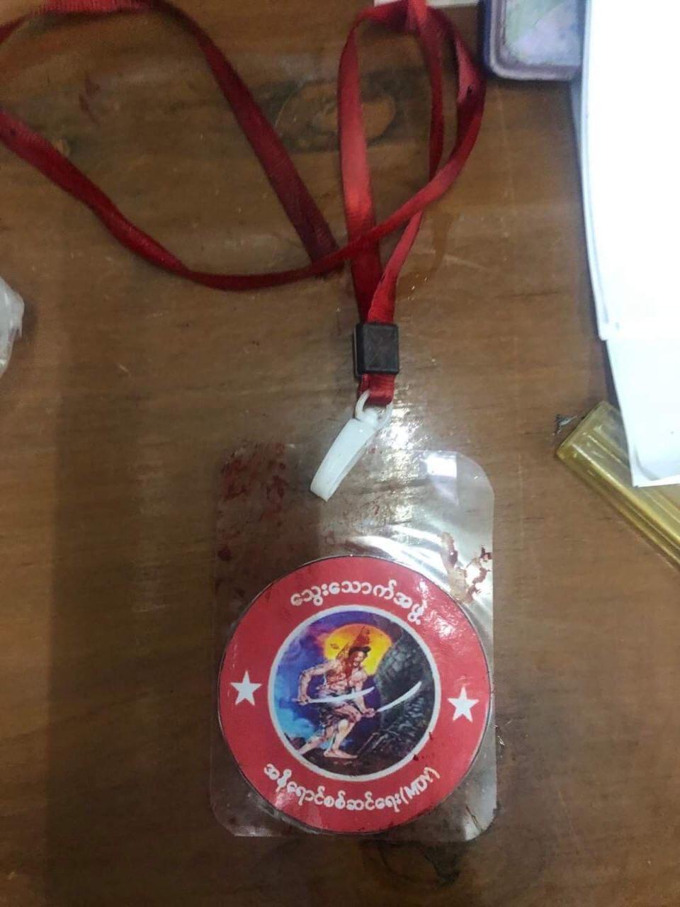 A blood stained symbol - a red circle depicting a warrior holding two swords - of the pro-military militia Thway Thauk Apwe on a desk