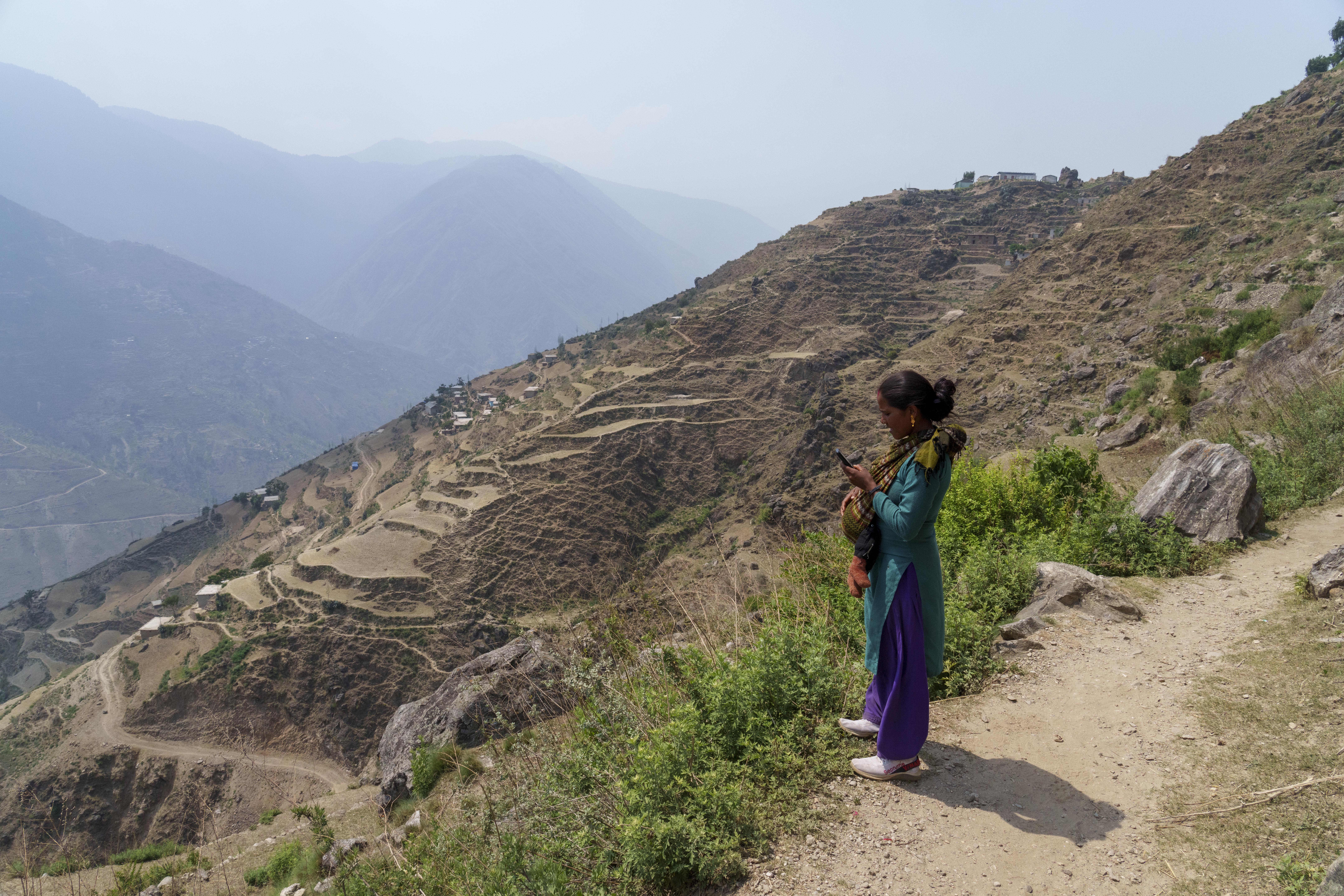 A woman checks her cell phone while she takes rest while she return