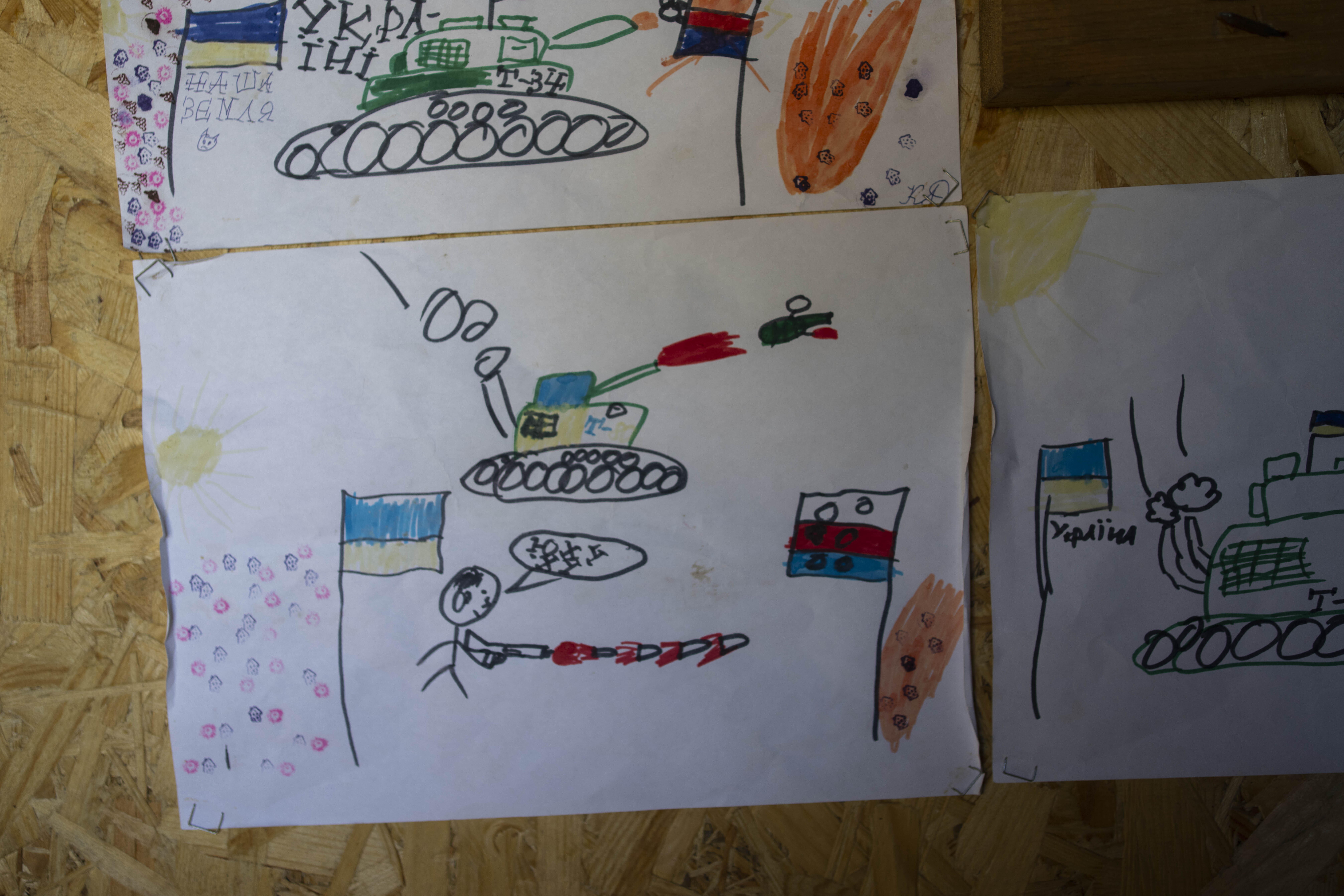 Drawings by Ukrainian children decorate a sleeping area in a trench near the front lines in the Donetsk region, eastern Ukraine, Wednesday, June 8, 2022