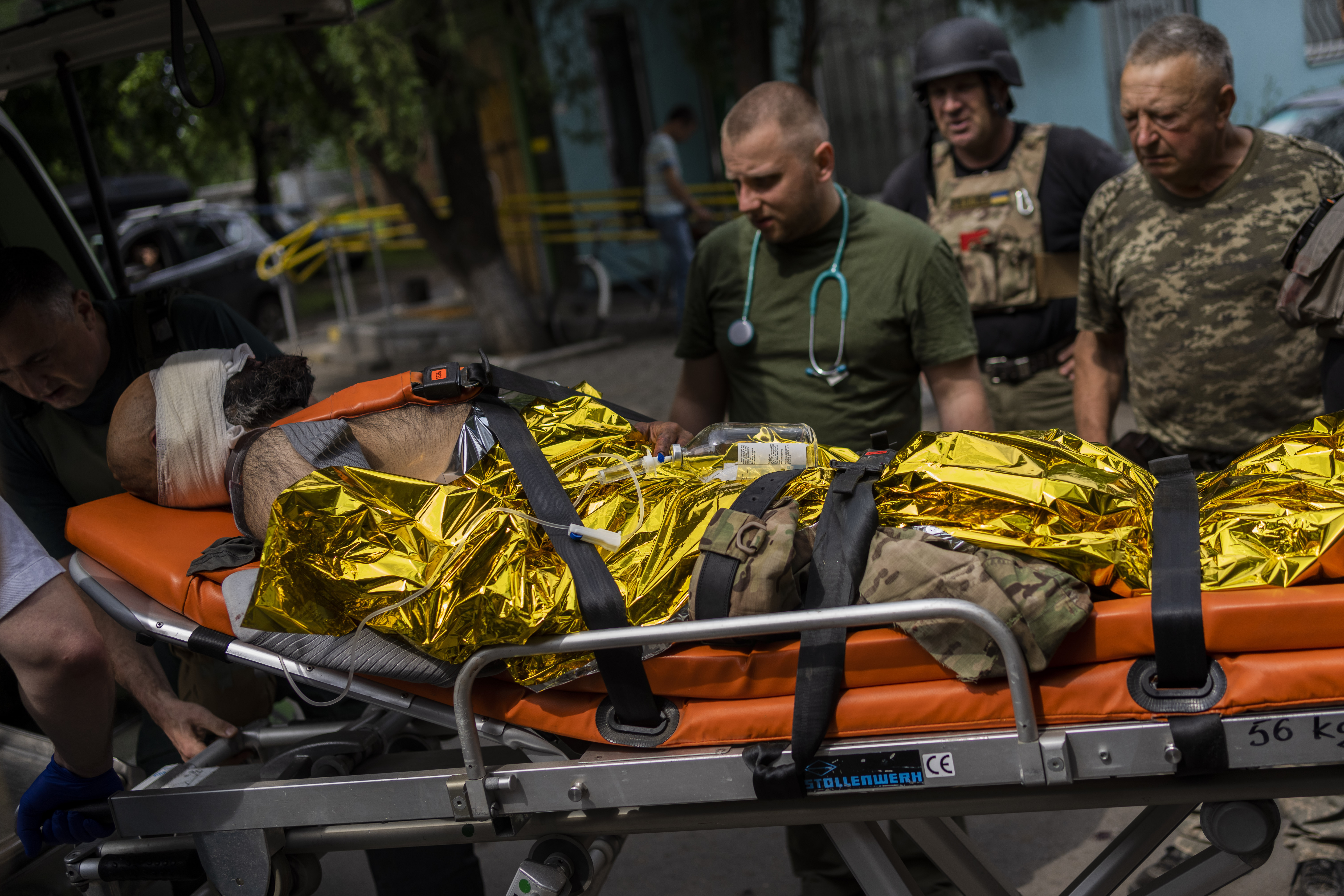 An injured Ukrainian serviceman is evacuated to a hospital in the Donetsk region, eastern Ukraine, Sunday, June 5, 2022
