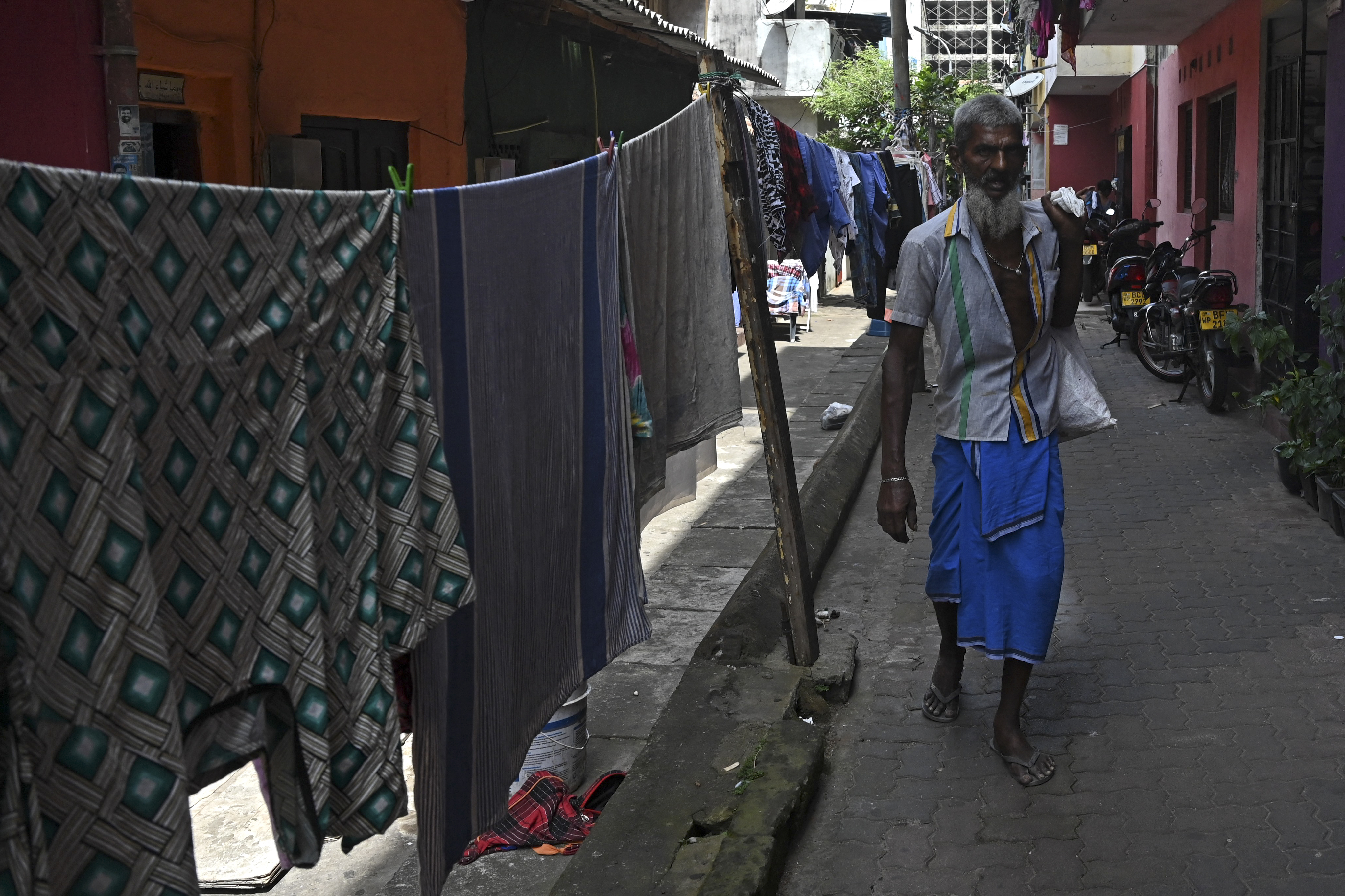 a man walking down an alleyway in the Slave Island