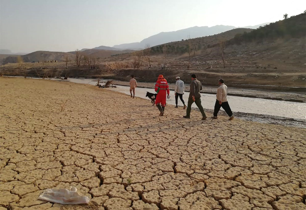 Rescue workers search near a river bank after flooding in Estahban county in souther Iran.