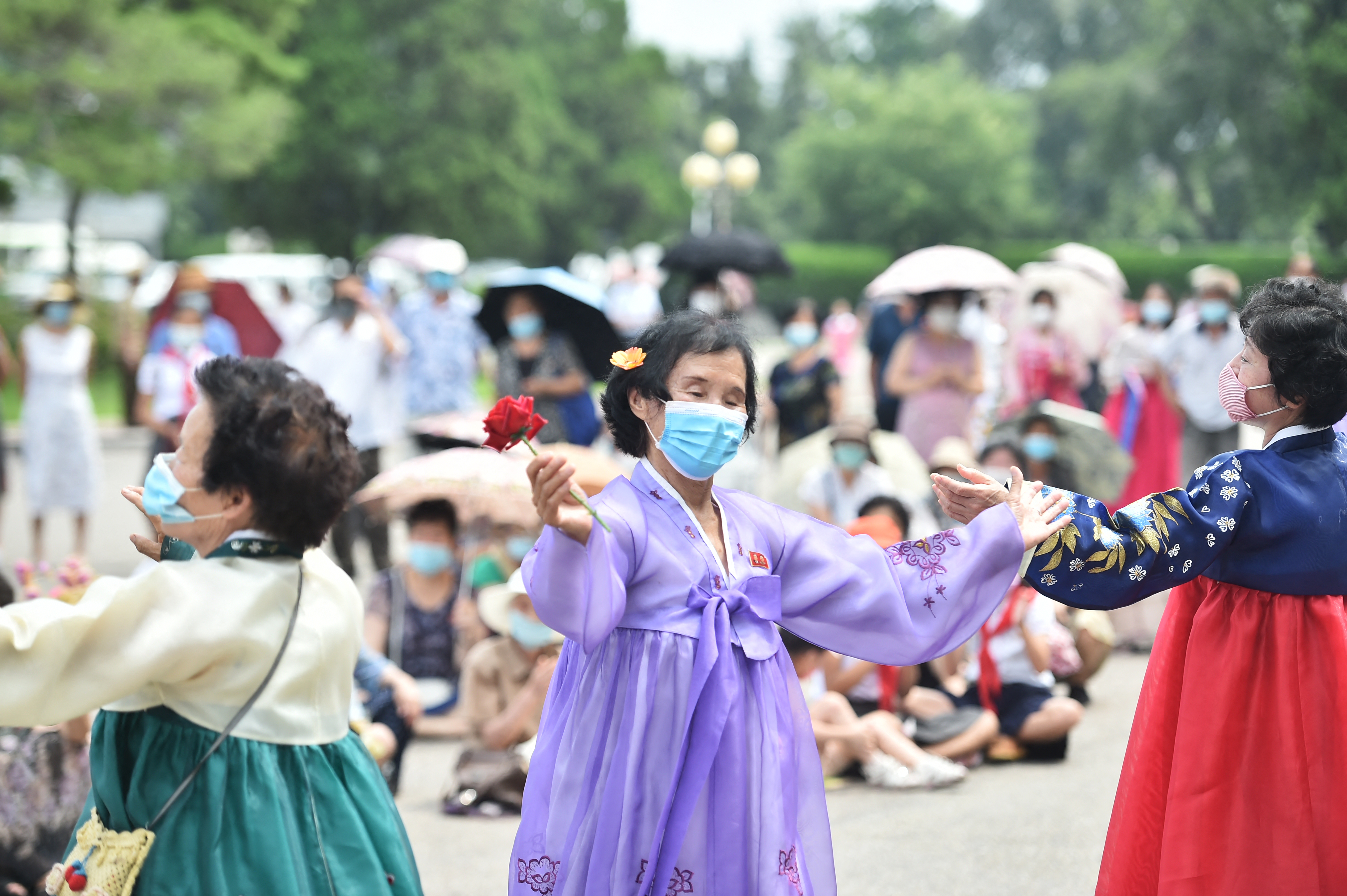 People dance at the plaza of the Pyongyang