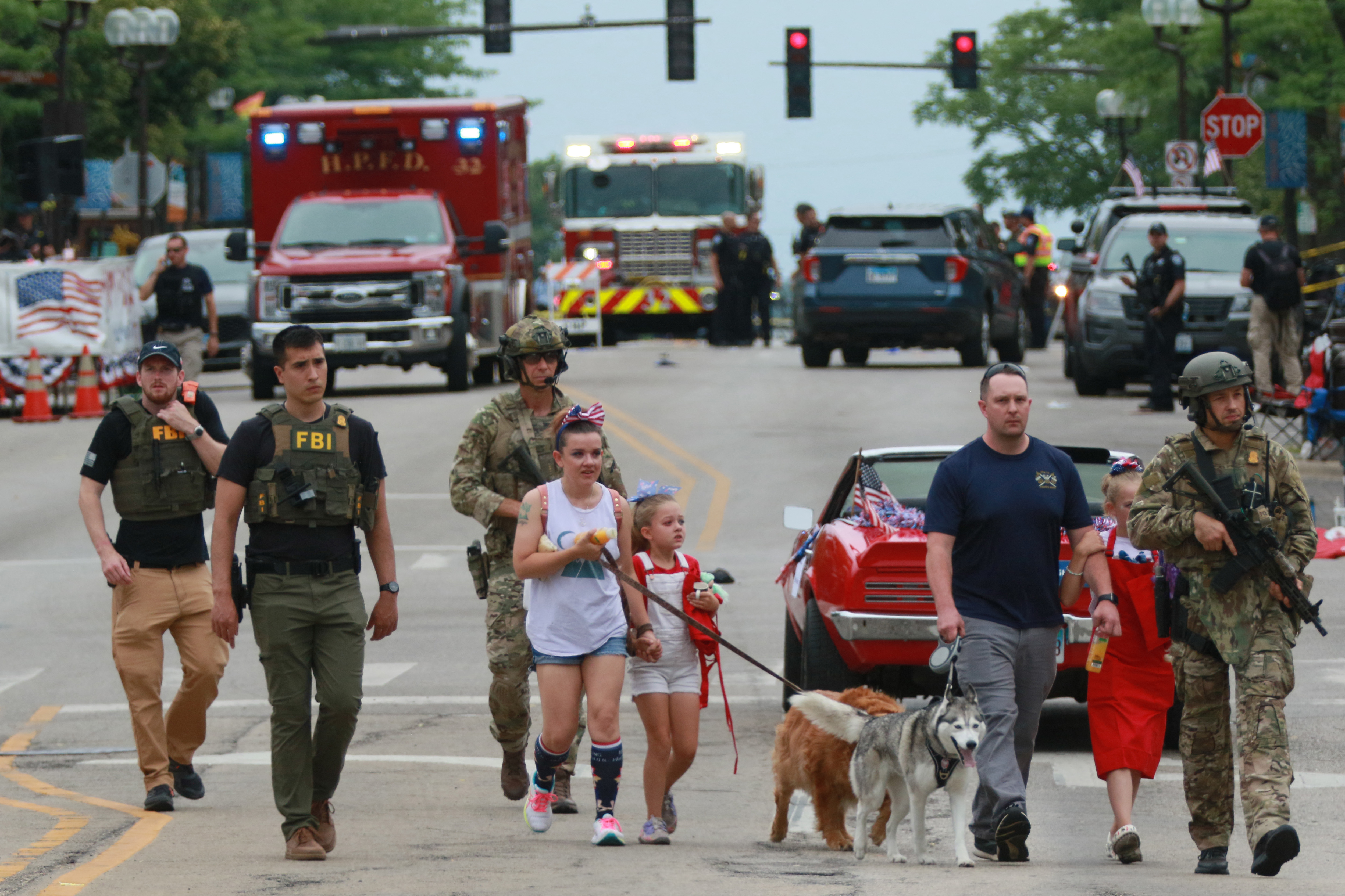 Law enforcement escorts a family away