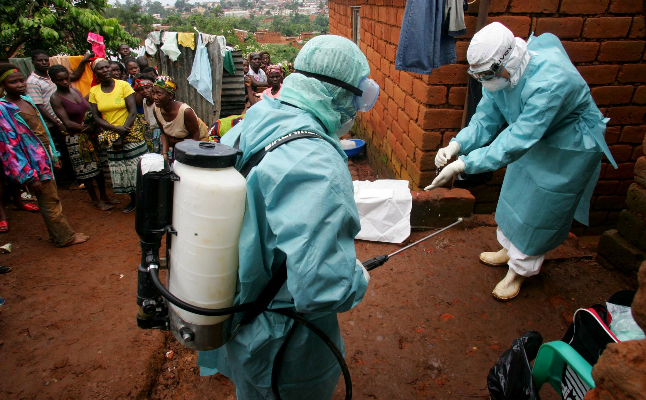 World Health Organisation officials examine the home of a suspected Marburg virus victim in the northern Angolan town of Uige