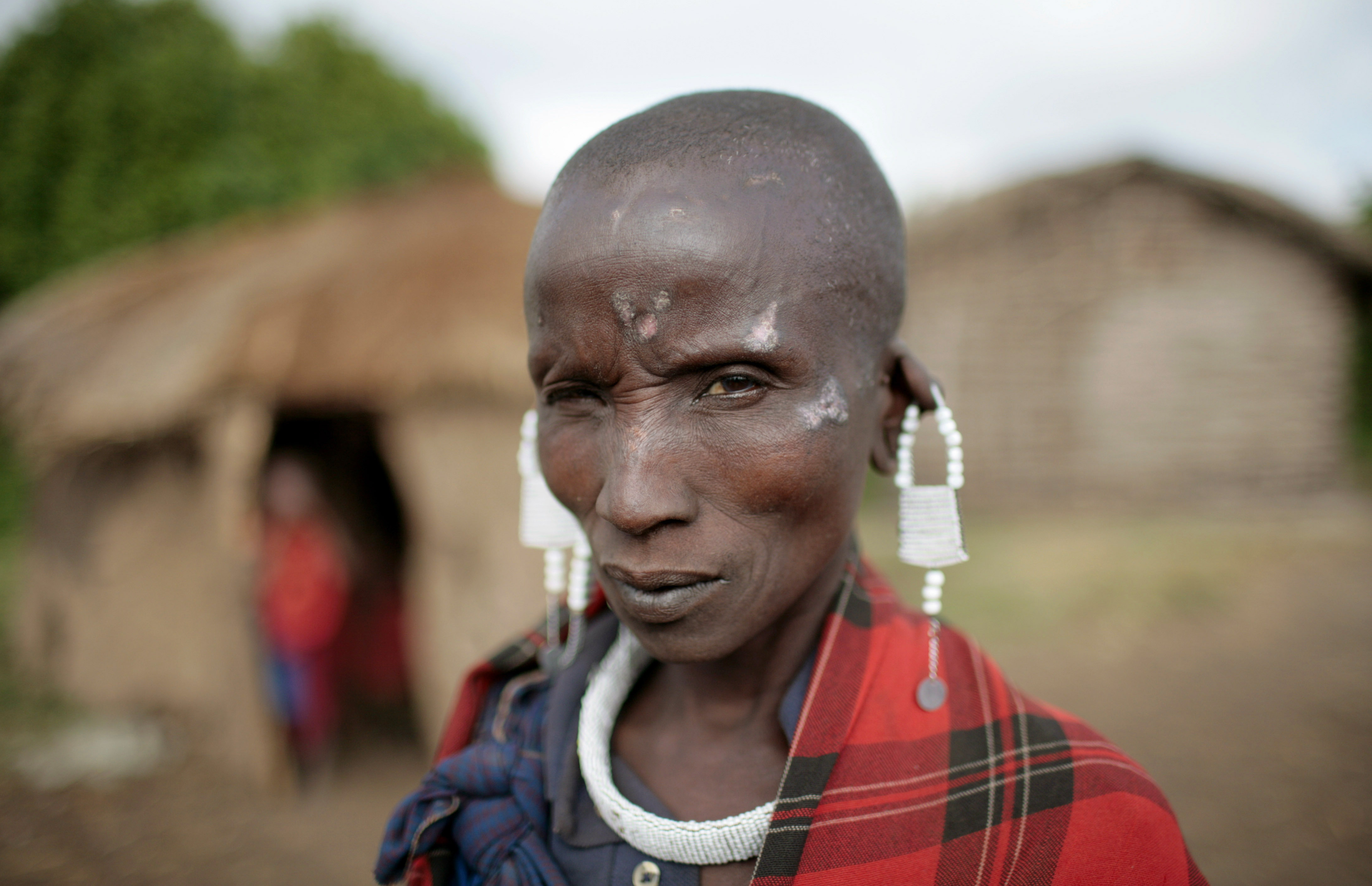 A Maasai woman displays hand made earrings made and sold in her village outside of Ngorongoro Crater, Tanzania.