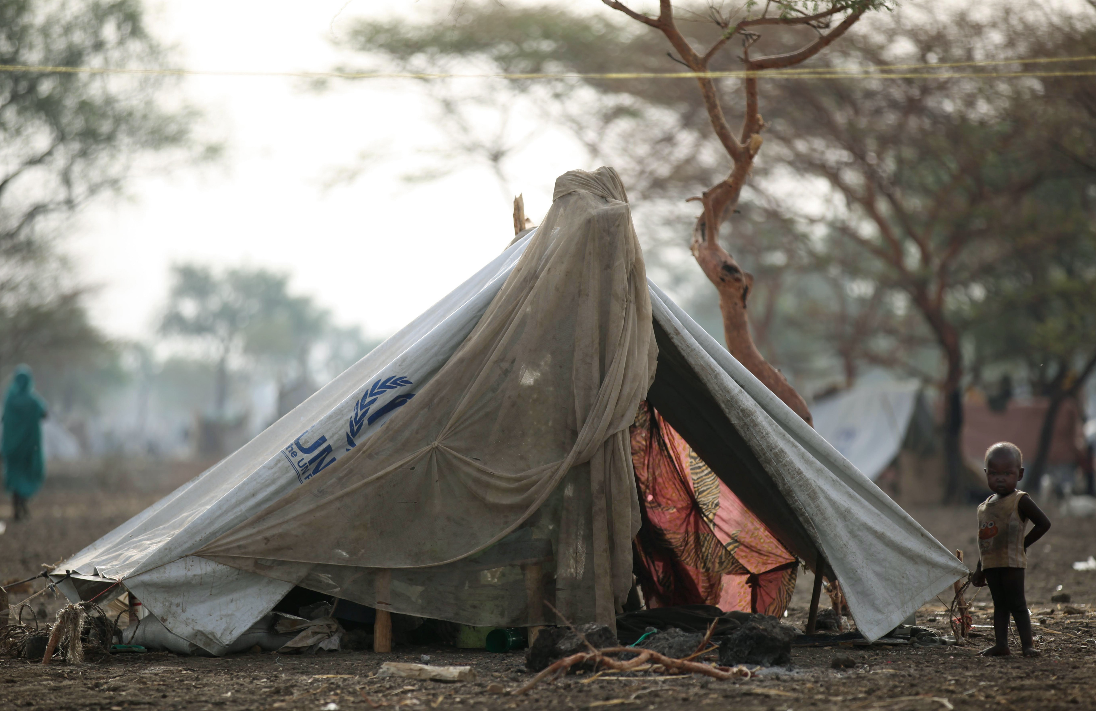 A displaced child stands outside their shelter at the Jamam refugee camp in South Sudan's Upper Nile State.