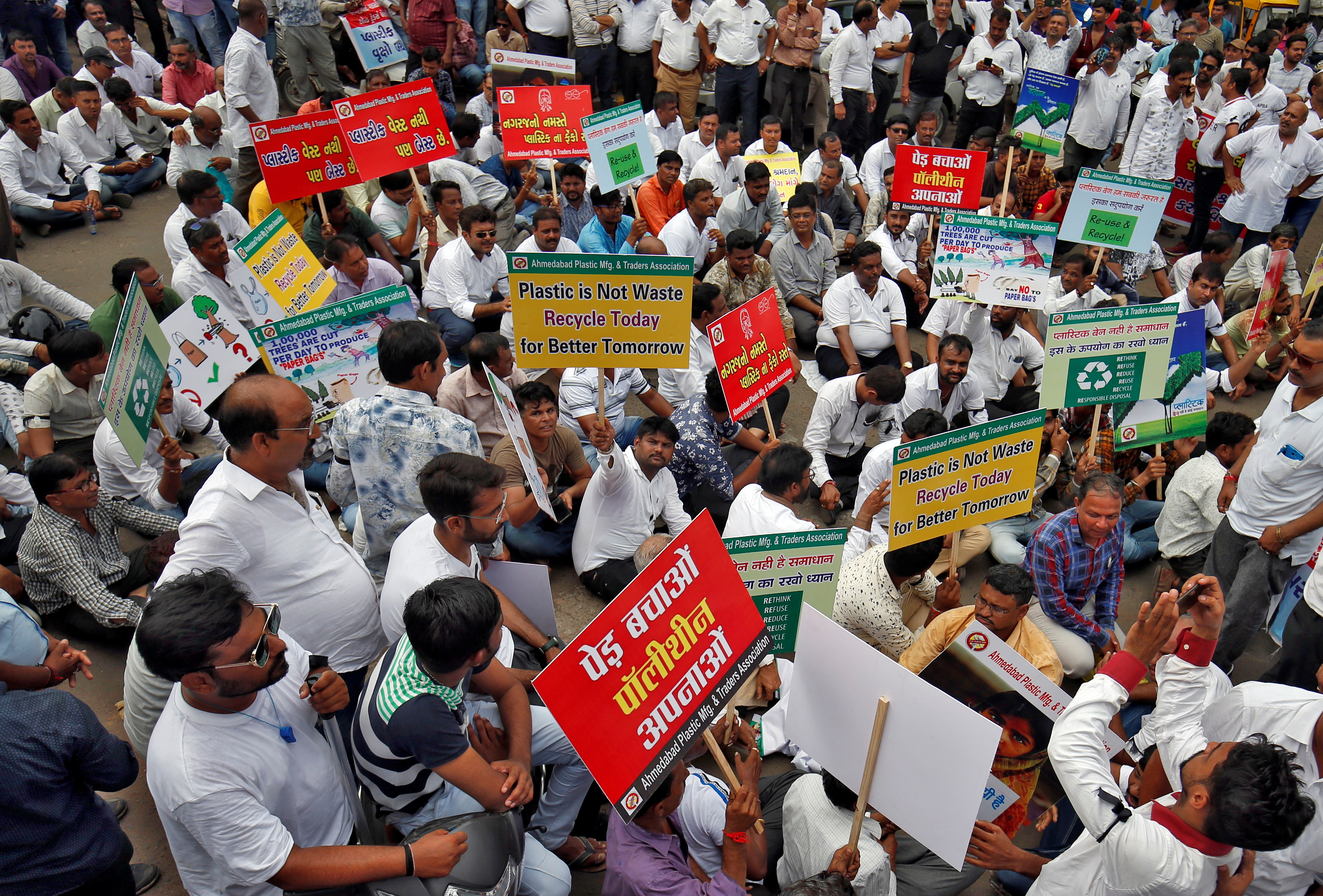 Traders hold placards as they take part in a protest rally against the central government's decision to impose a nationwide ban on single-use plastic products, in Ahmedabad, India