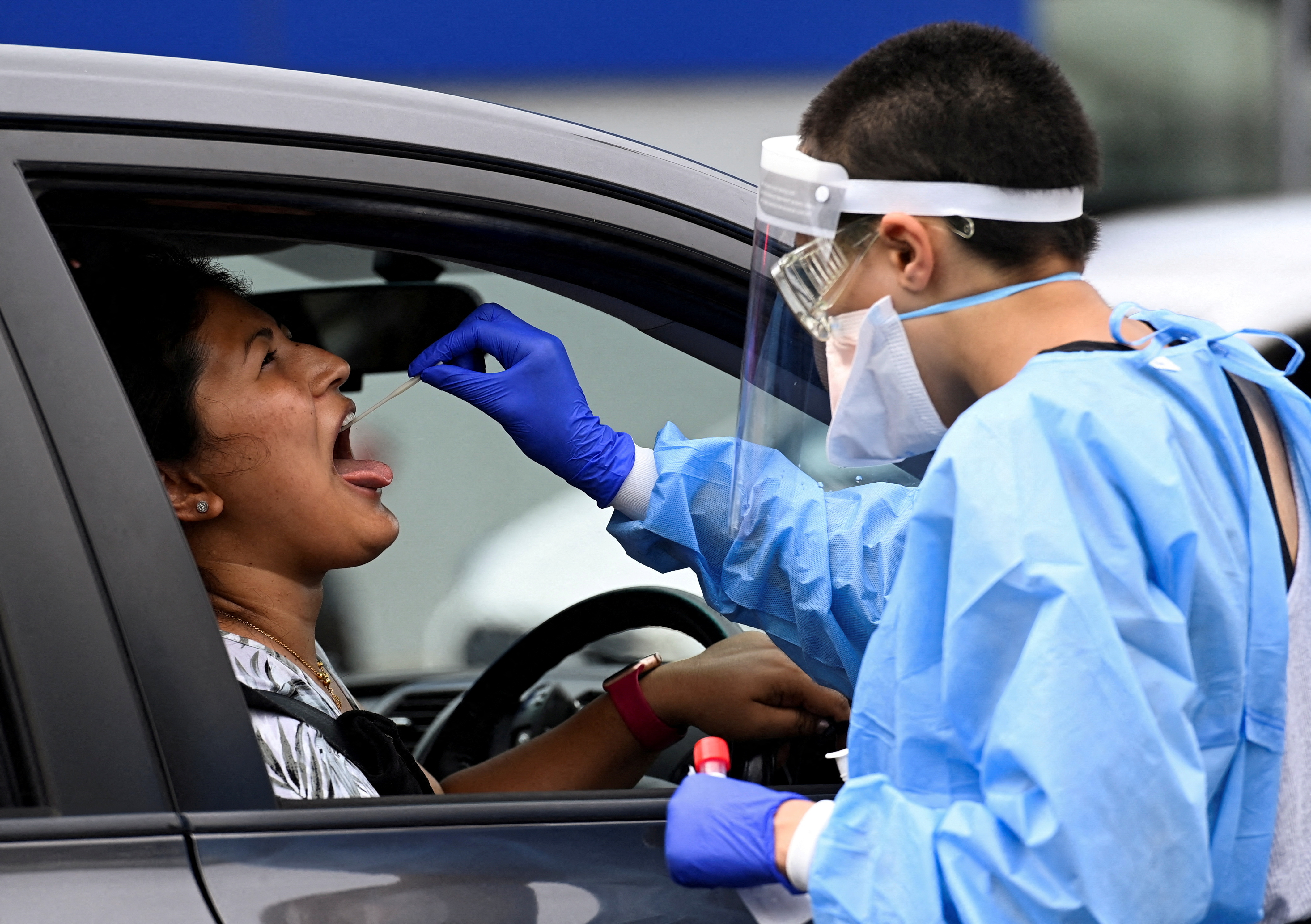 A woman is tested for COVID-19 at a drive-thru testing site in Sydney, Australia.