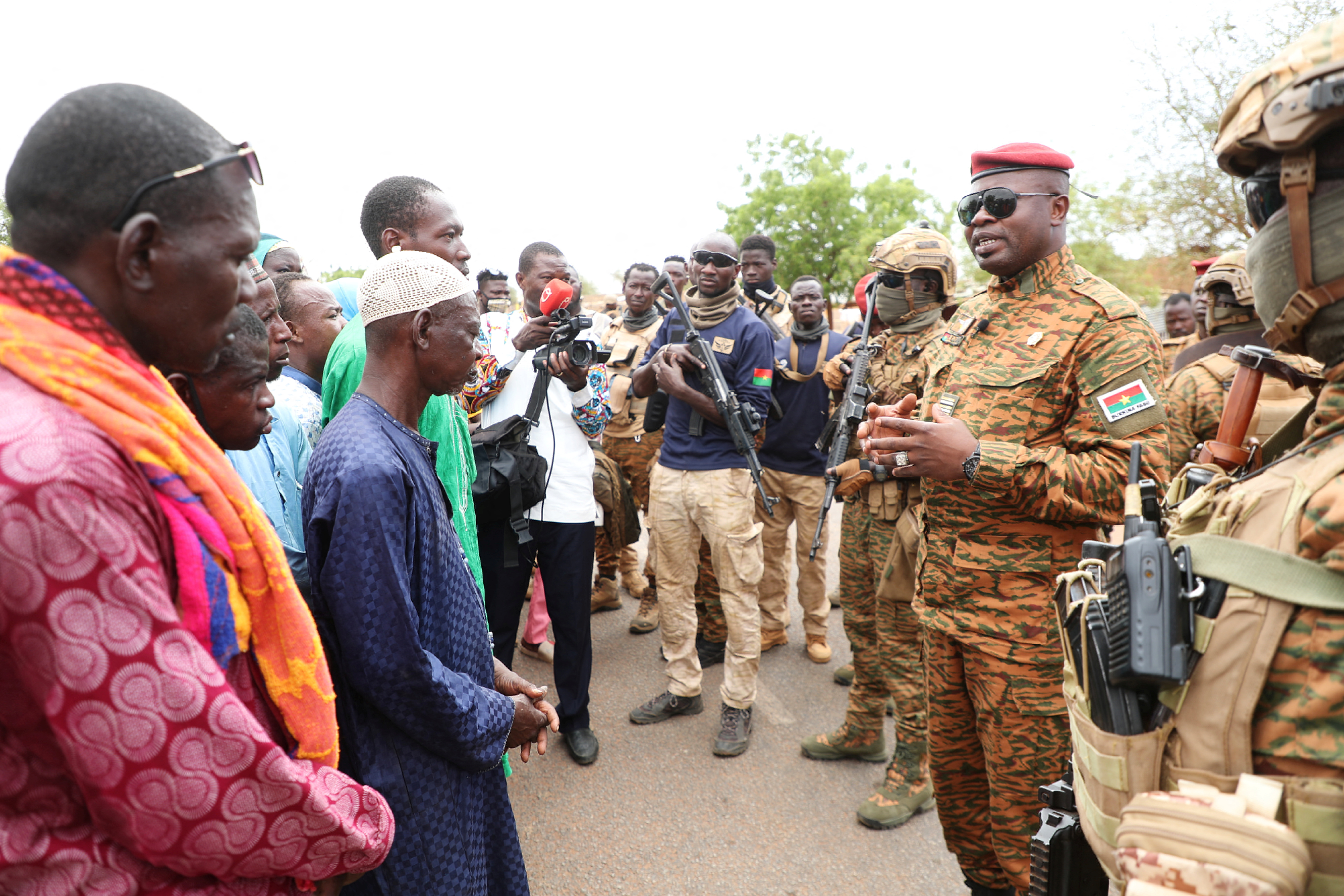 Burkina Faso President Lieutenant Colonel Paul-Henri Damiba talks to local people, after armed men killed civilians and militaries in Seytenga