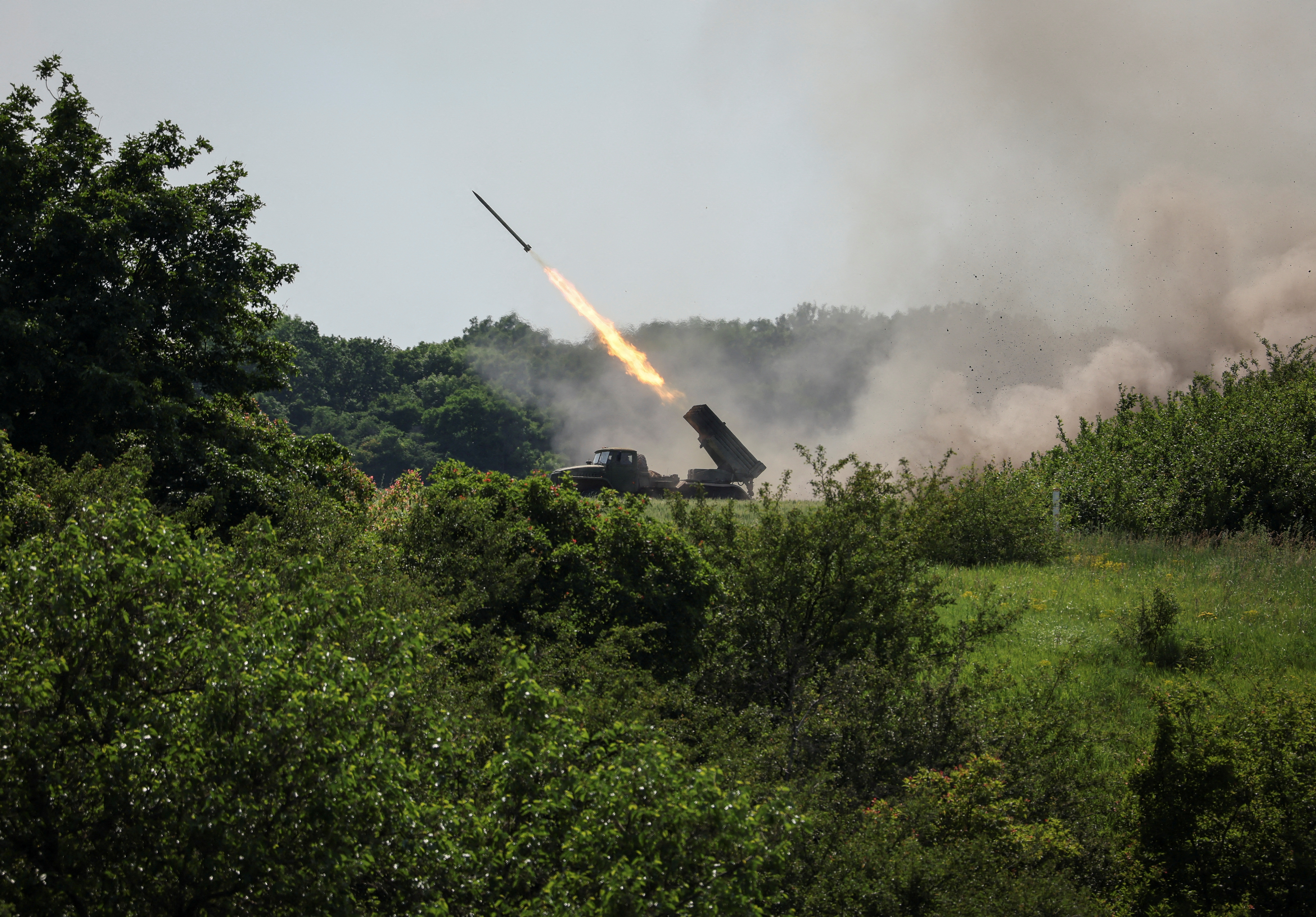 Ukrainian service members fire a BM-21 Grad multiple rocket launch system, near the town of Lysychansk, Ukraine.