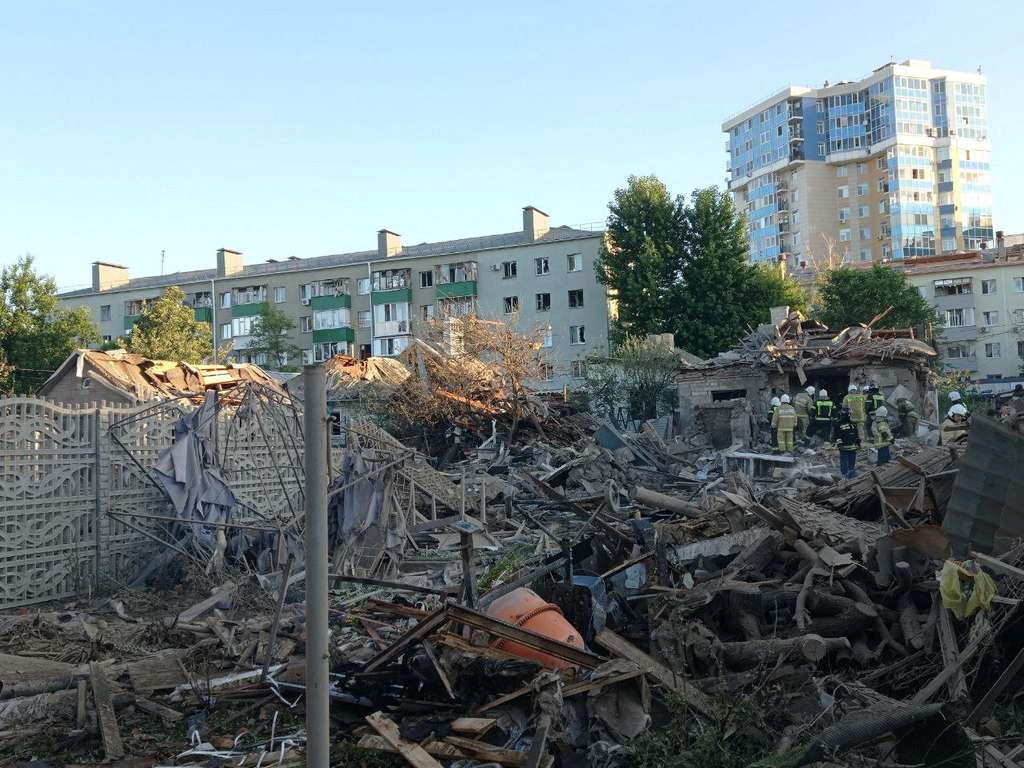 Rescue specialists work at the site of a destroyed residential building after the blasts in Belgorod