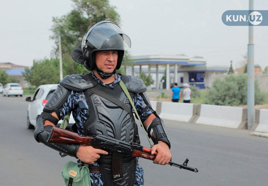 An Uzbek law enforcement officer guards a street in Nukus