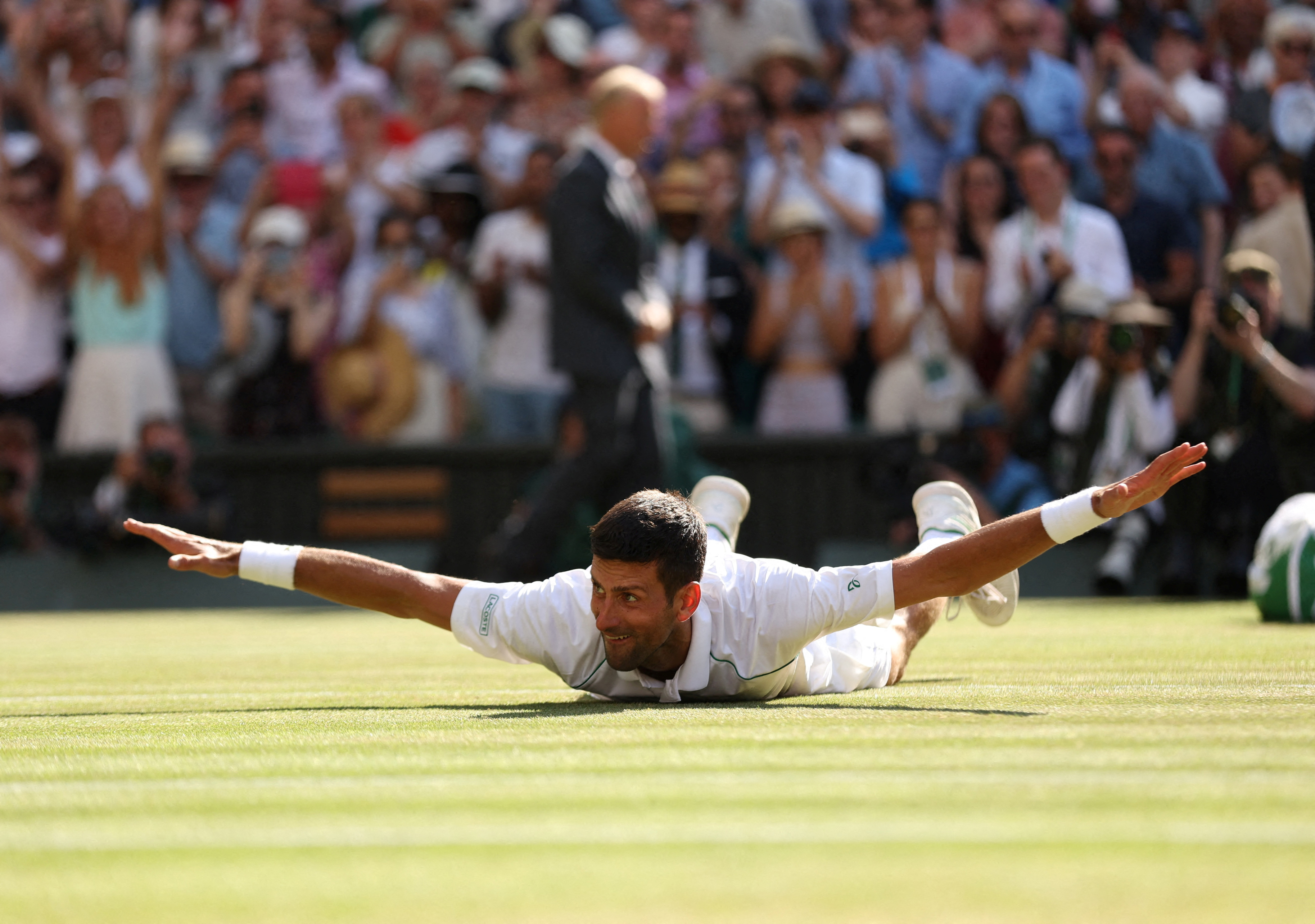 Serbia's Novak Djokovic celebrates after winning the men's singles final against Australia's Nick Kyrgios on July 10, 2022 [Matthew Childs/Reuter